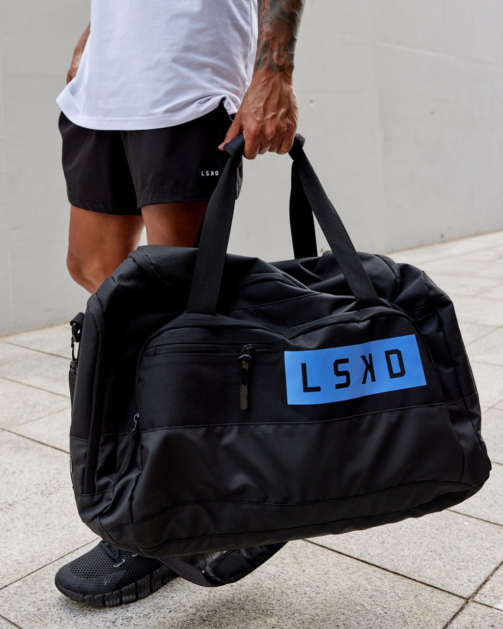 Model wearing Rep Duffle Bag 50L - Black-Cornflower Blue