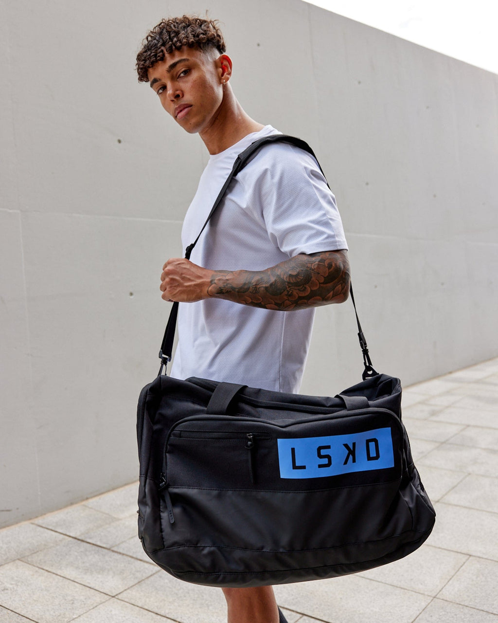 Model wearing Rep Duffle Bag 50L - Black-Cornflower Blue