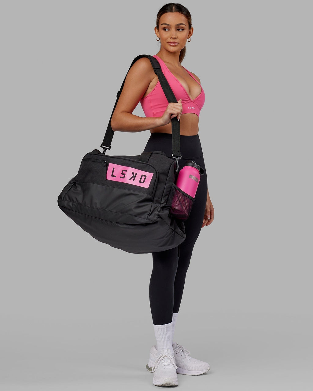 Model wearing Rep Duffle Bag 50L - Black-Flamingo
