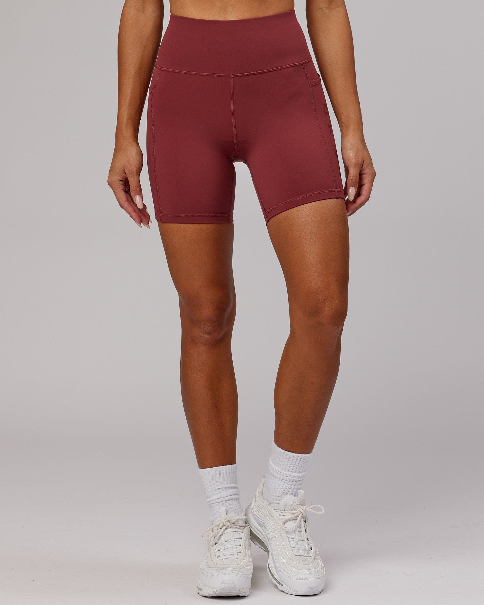 Model wearing Rep Mid Short Tight - Apple Berry