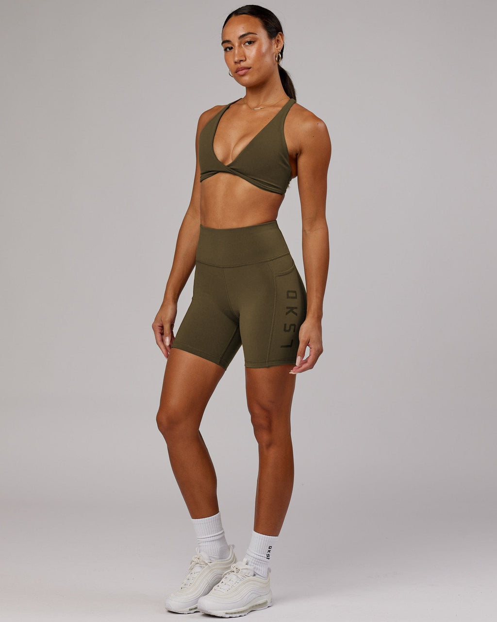 Model wearing Rep Mid Short Tight - Army Green