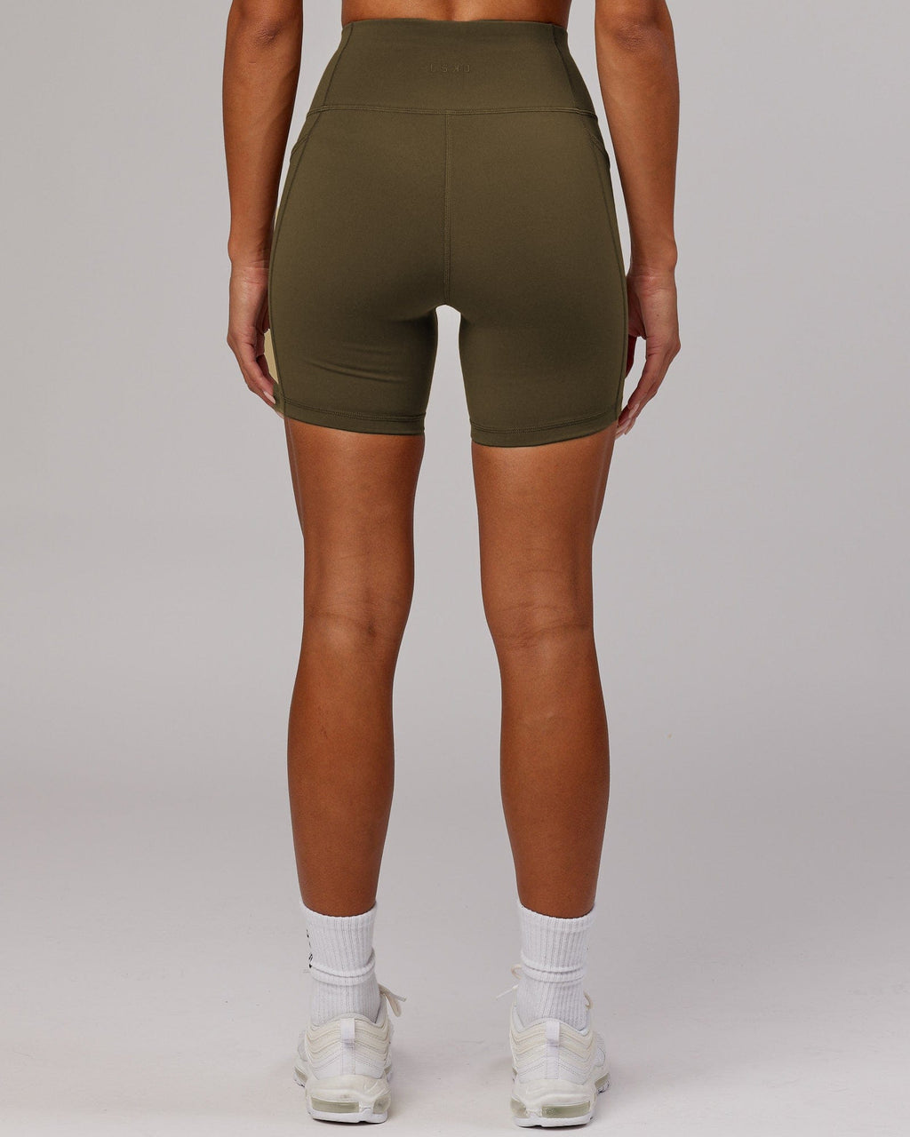 Model wearing Rep Mid Short Tight - Army Green