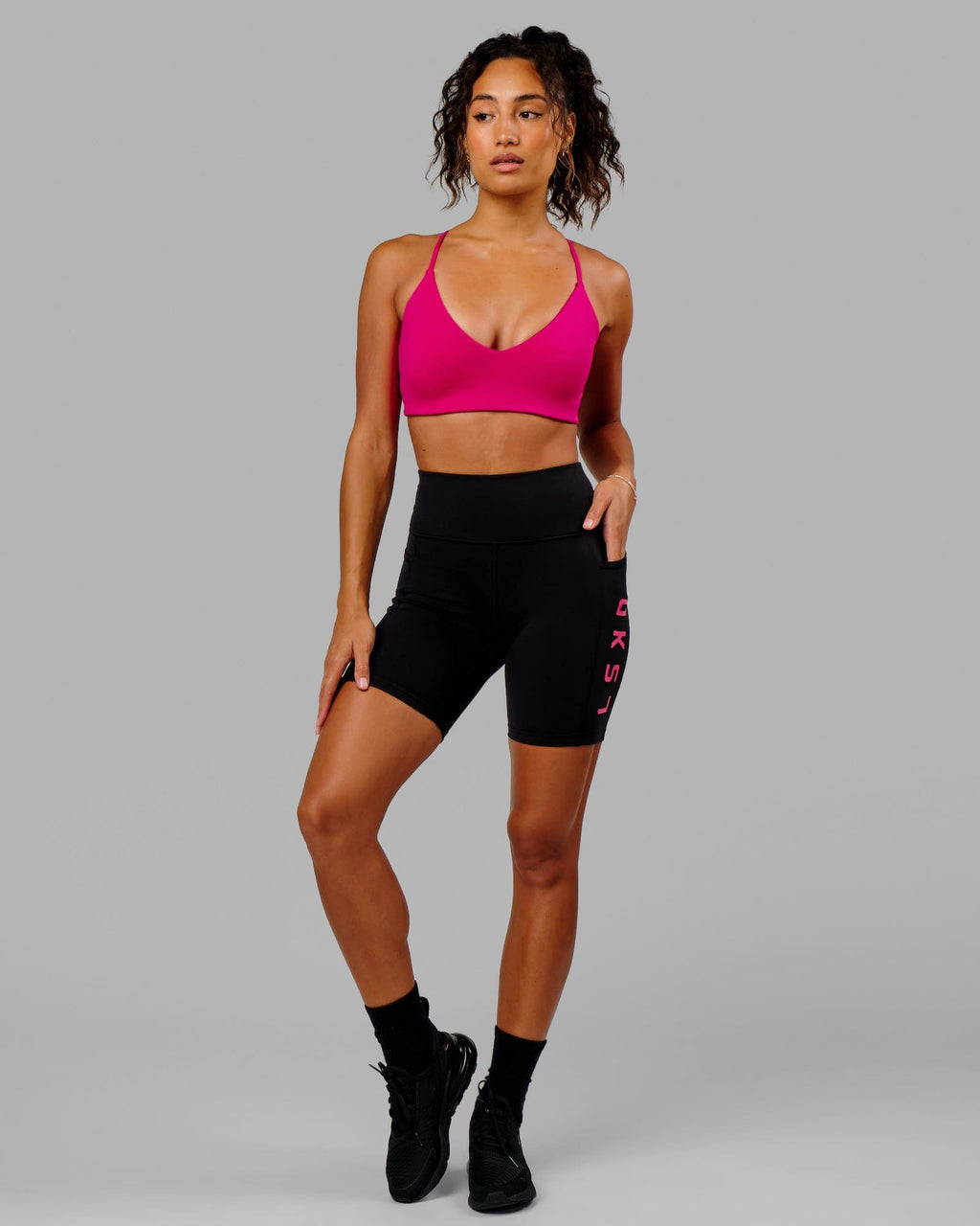 Model wearing Rep Mid Short Tight - Black-Boysenberry