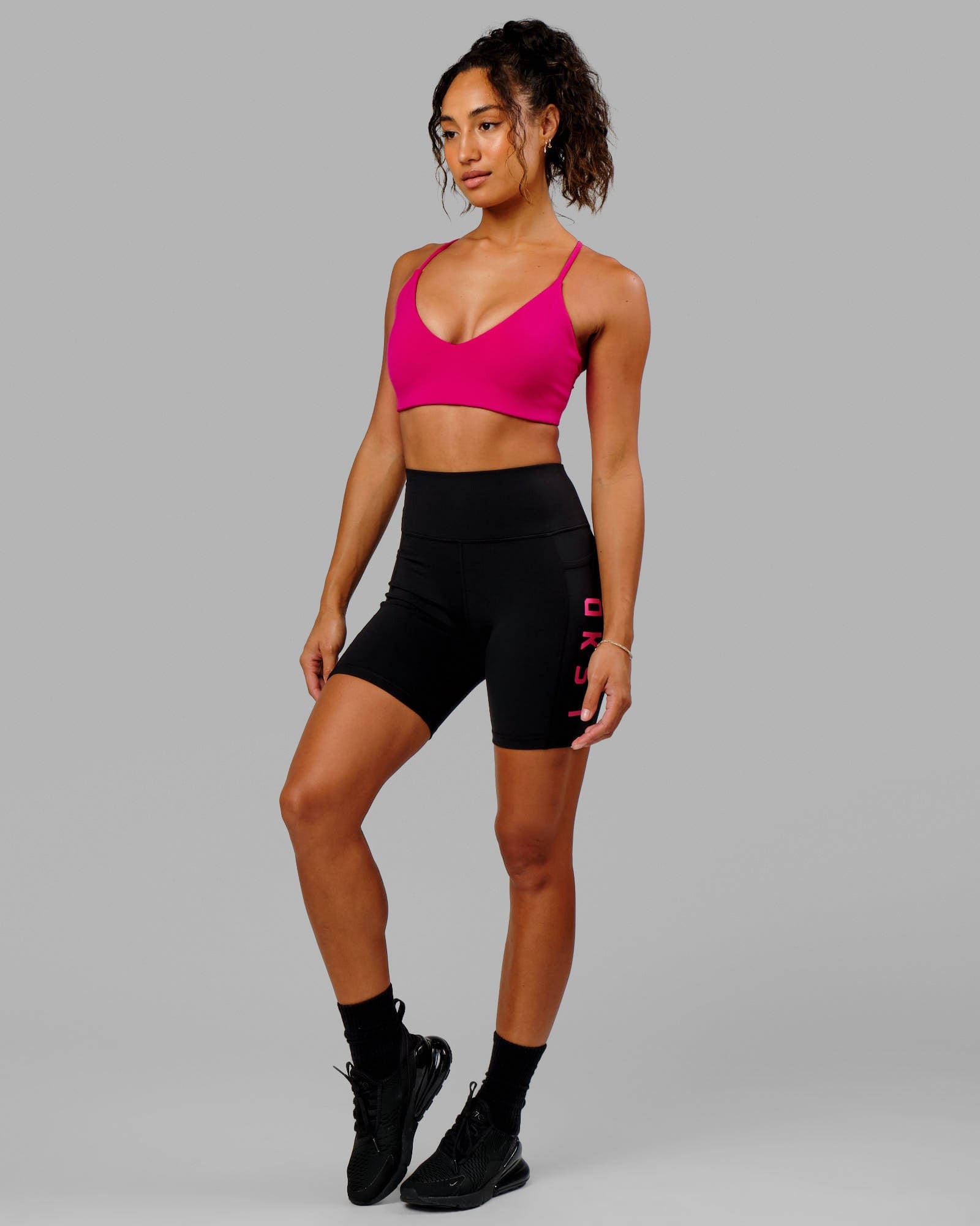 Model wearing Rep Mid Short Tight - Black-Boysenberry