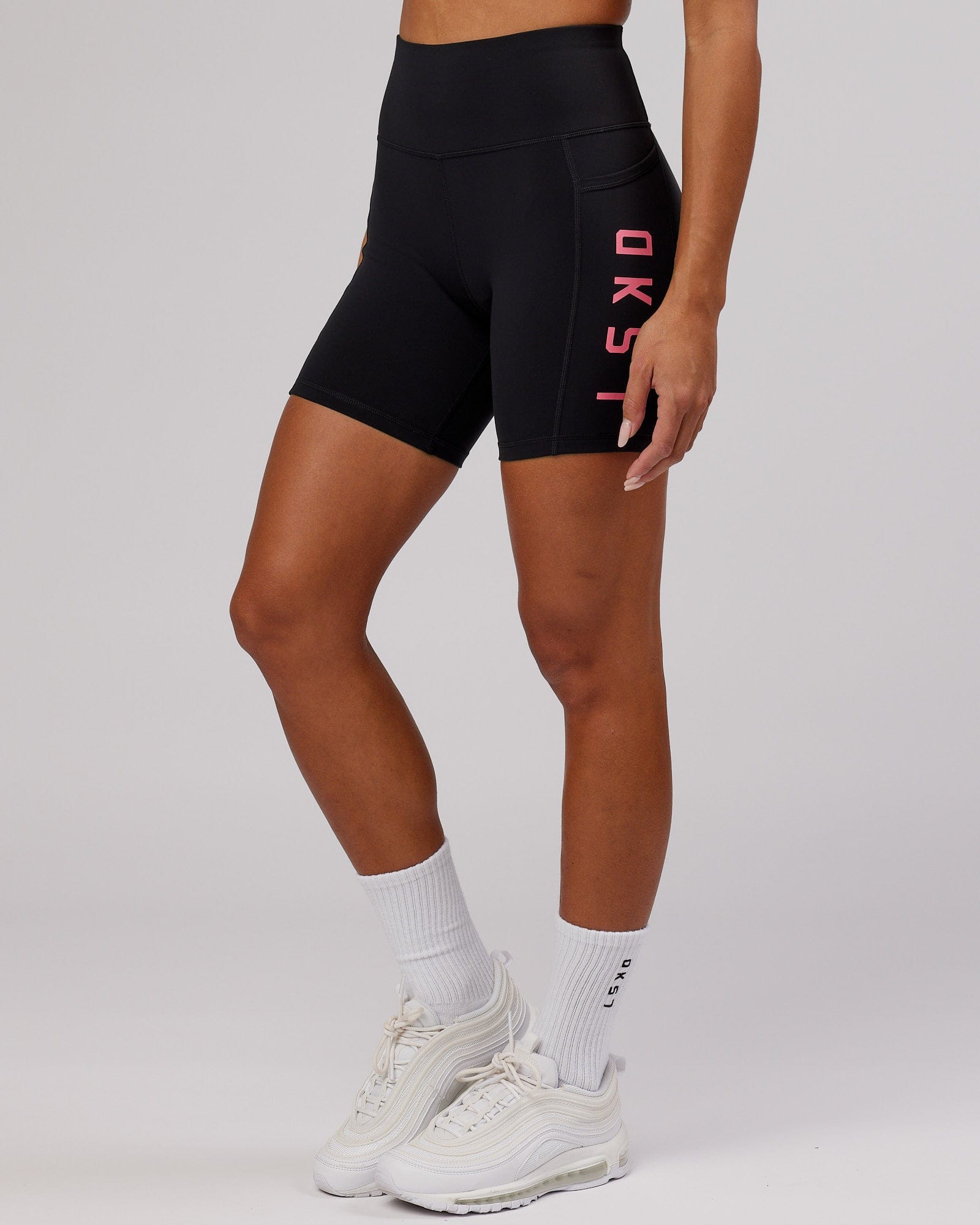 Model wearing Rep Mid Short Tight - Black-Flamingo