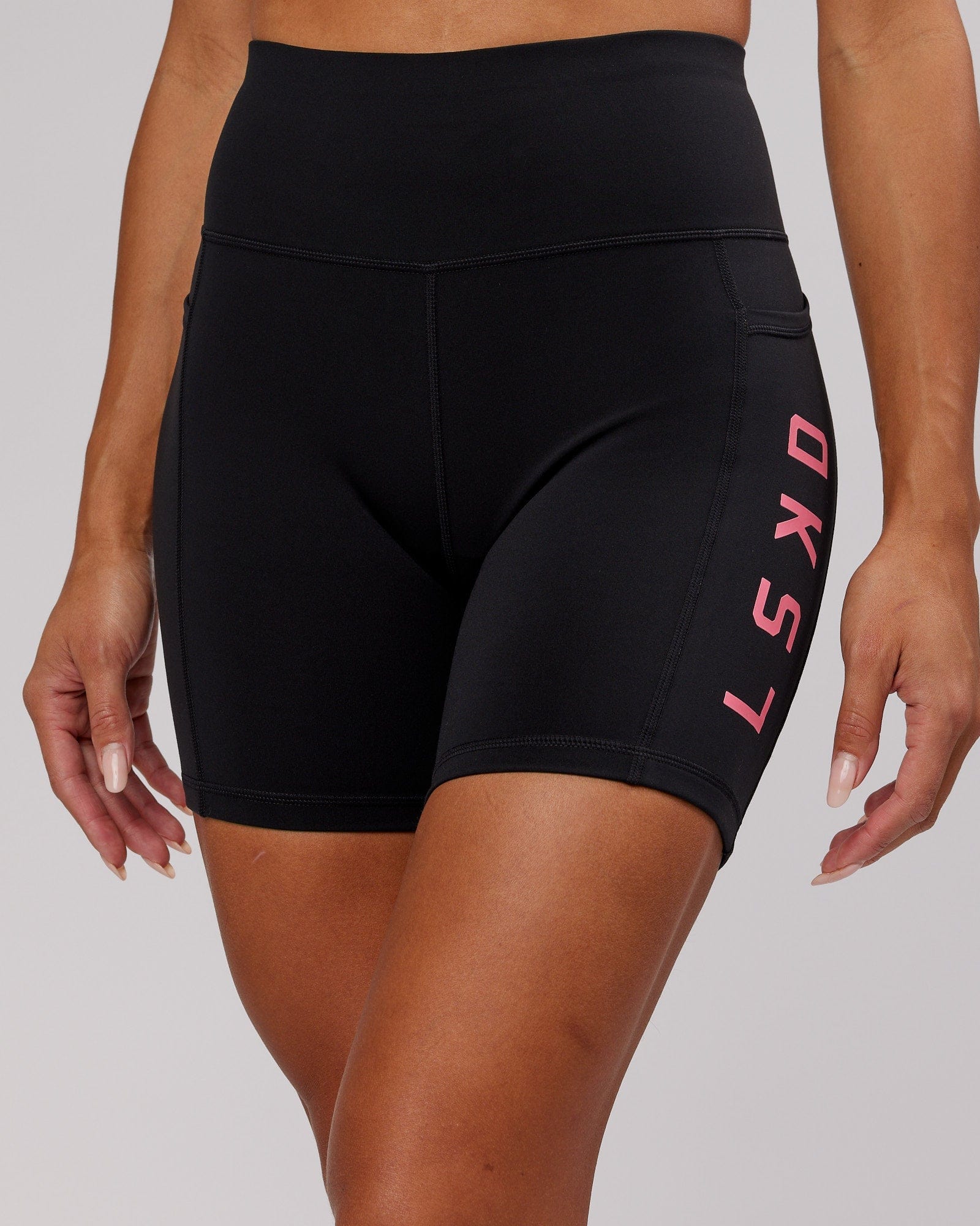 Model wearing Rep Mid Short Tight - Black-Flamingo