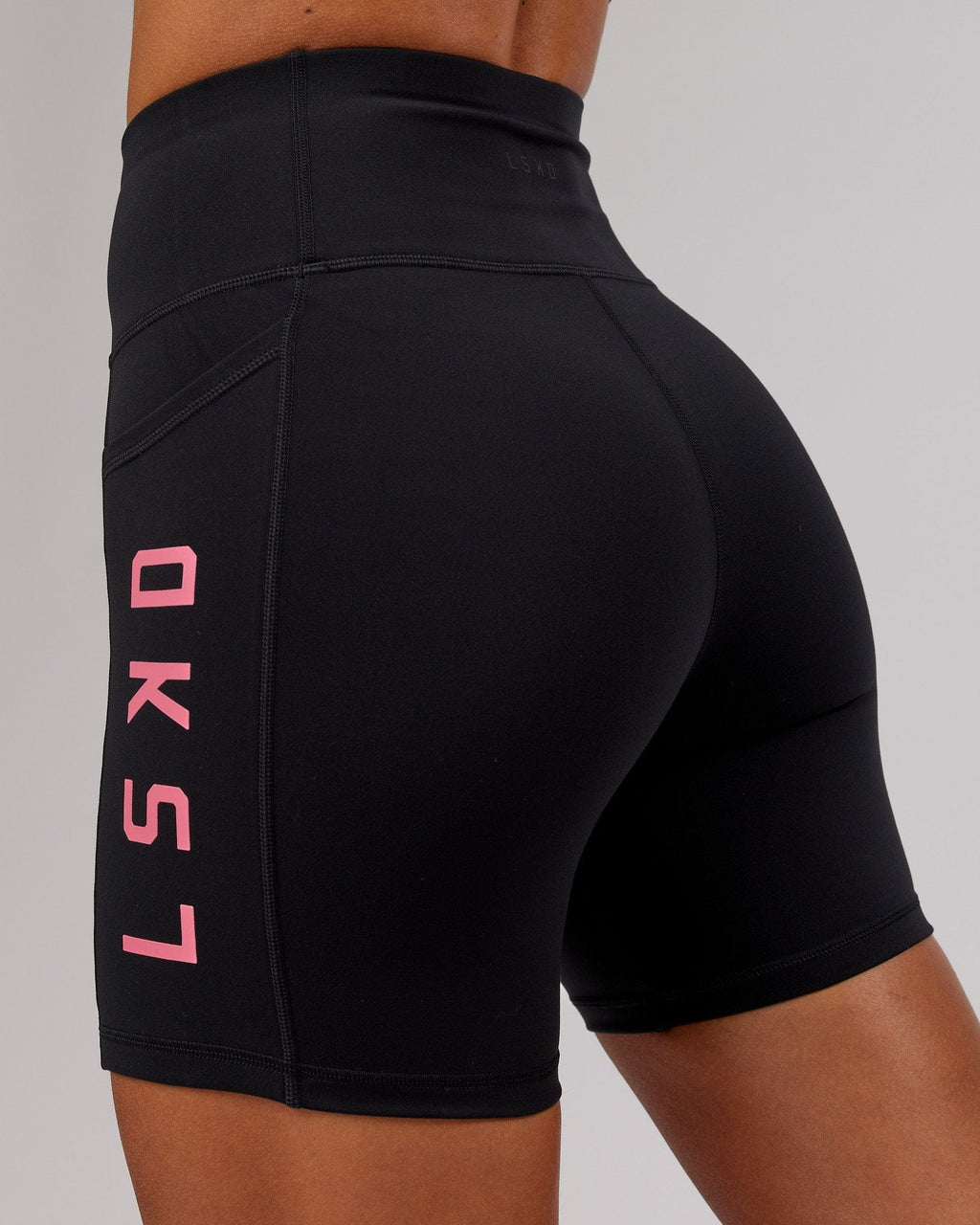 Model wearing Rep Mid Short Tight - Black-Flamingo