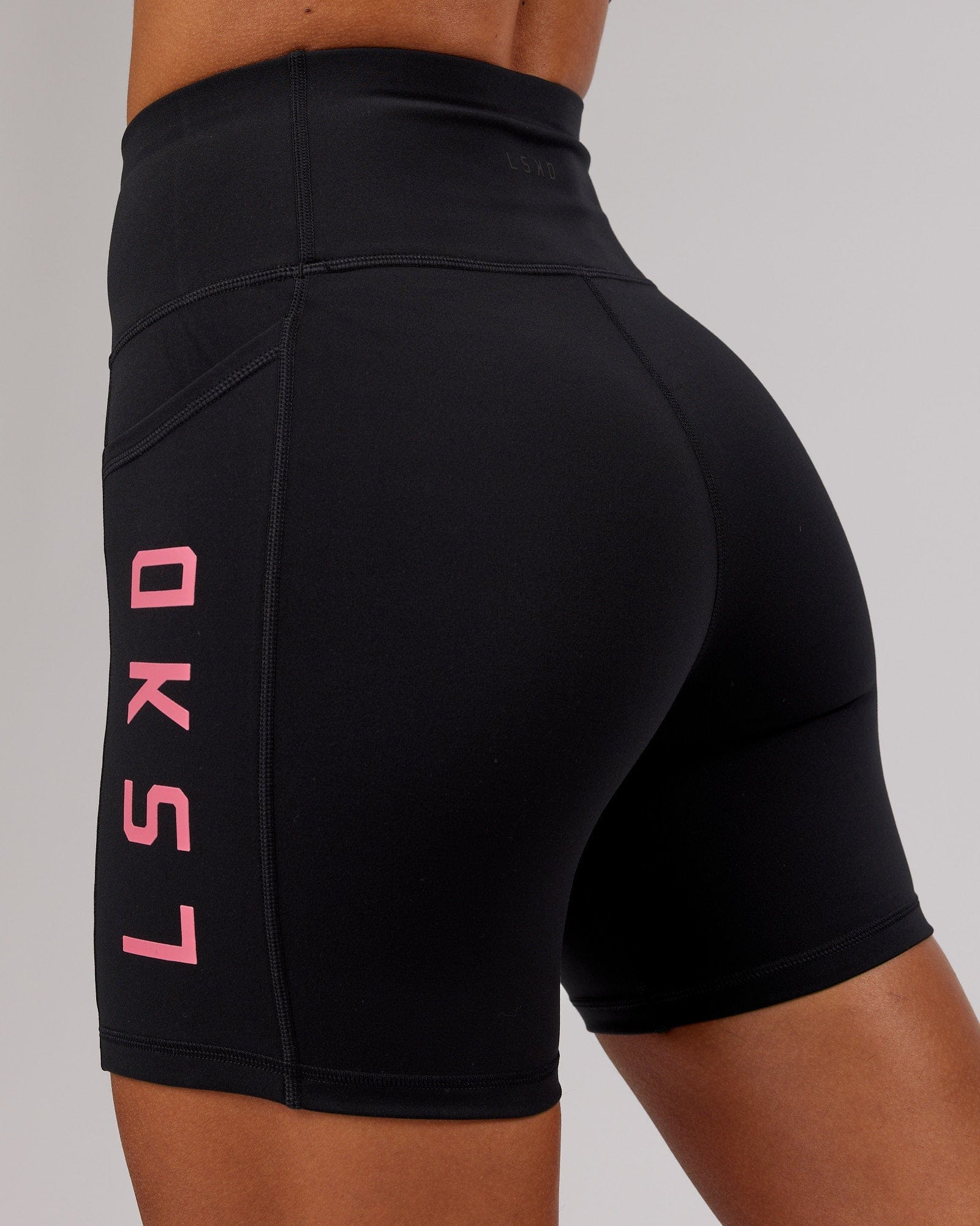 Model wearing Rep Mid Short Tight - Black-Flamingo