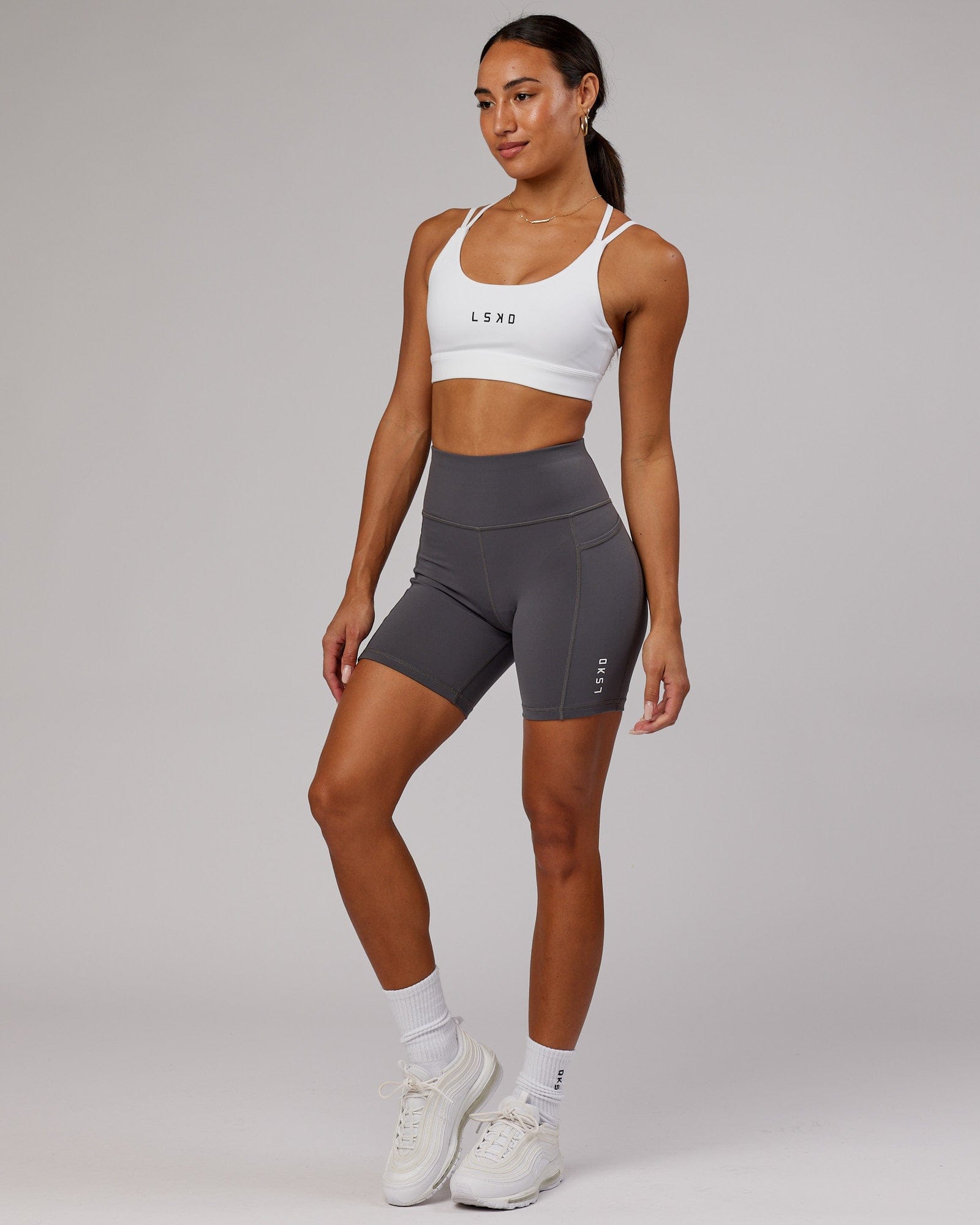 Model wearing Rep Mid Short Tight Small Logo - Asphalt