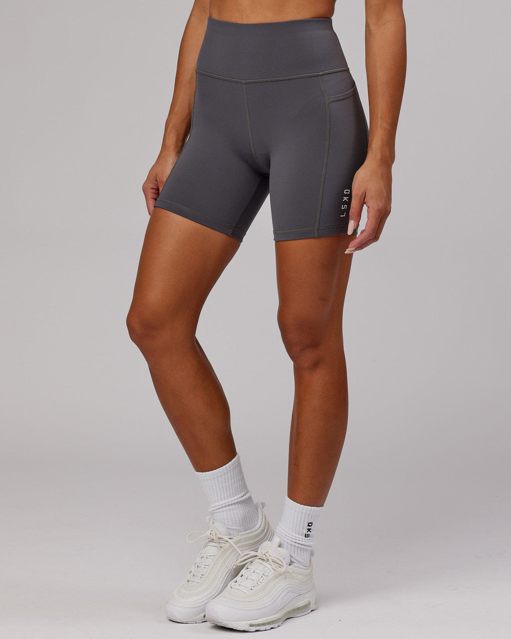 Model wearing Rep Mid Short Tight Small Logo - Asphalt