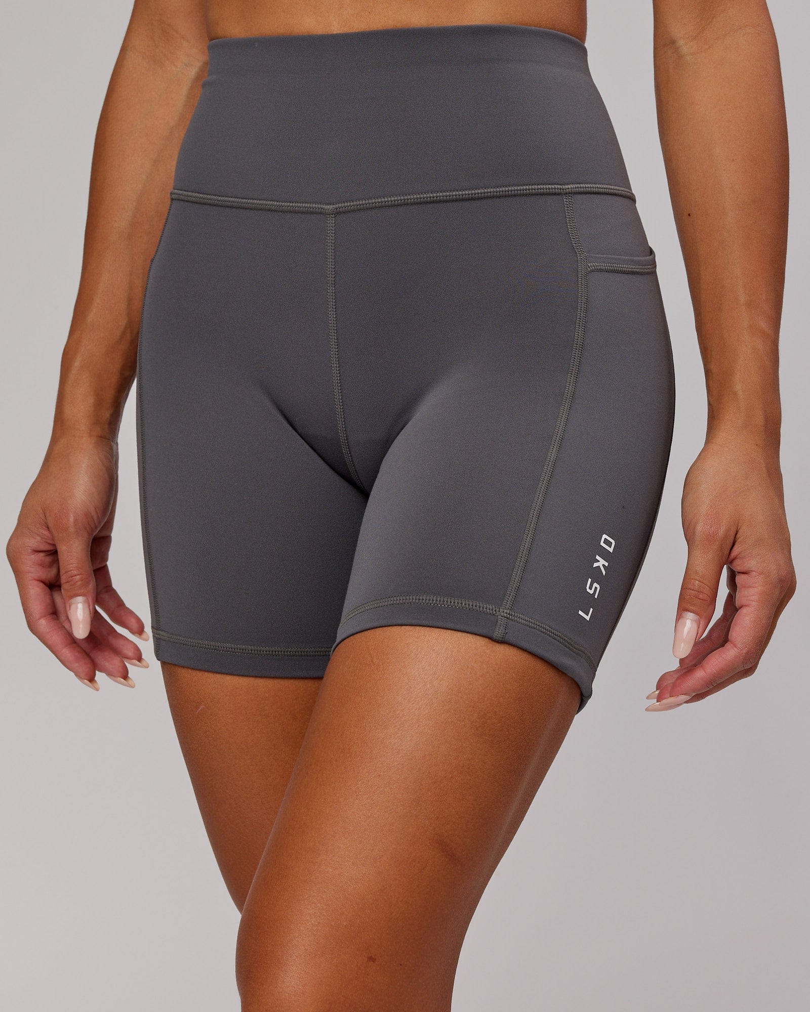 Model wearing Rep Mid Short Tight Small Logo - Asphalt