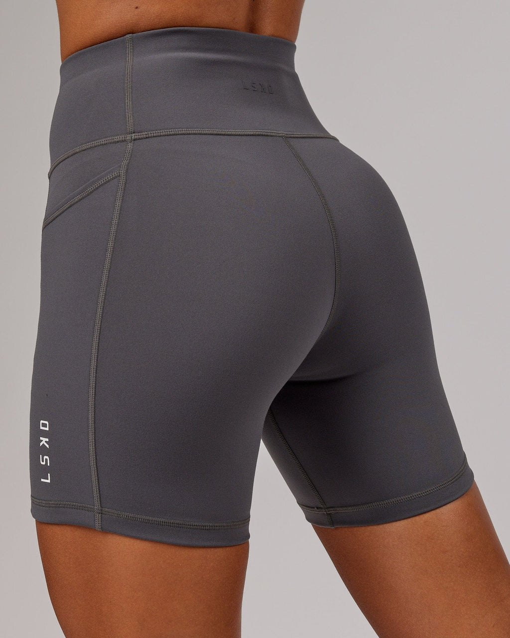 Model wearing Rep Mid Short Tight Small Logo - Asphalt