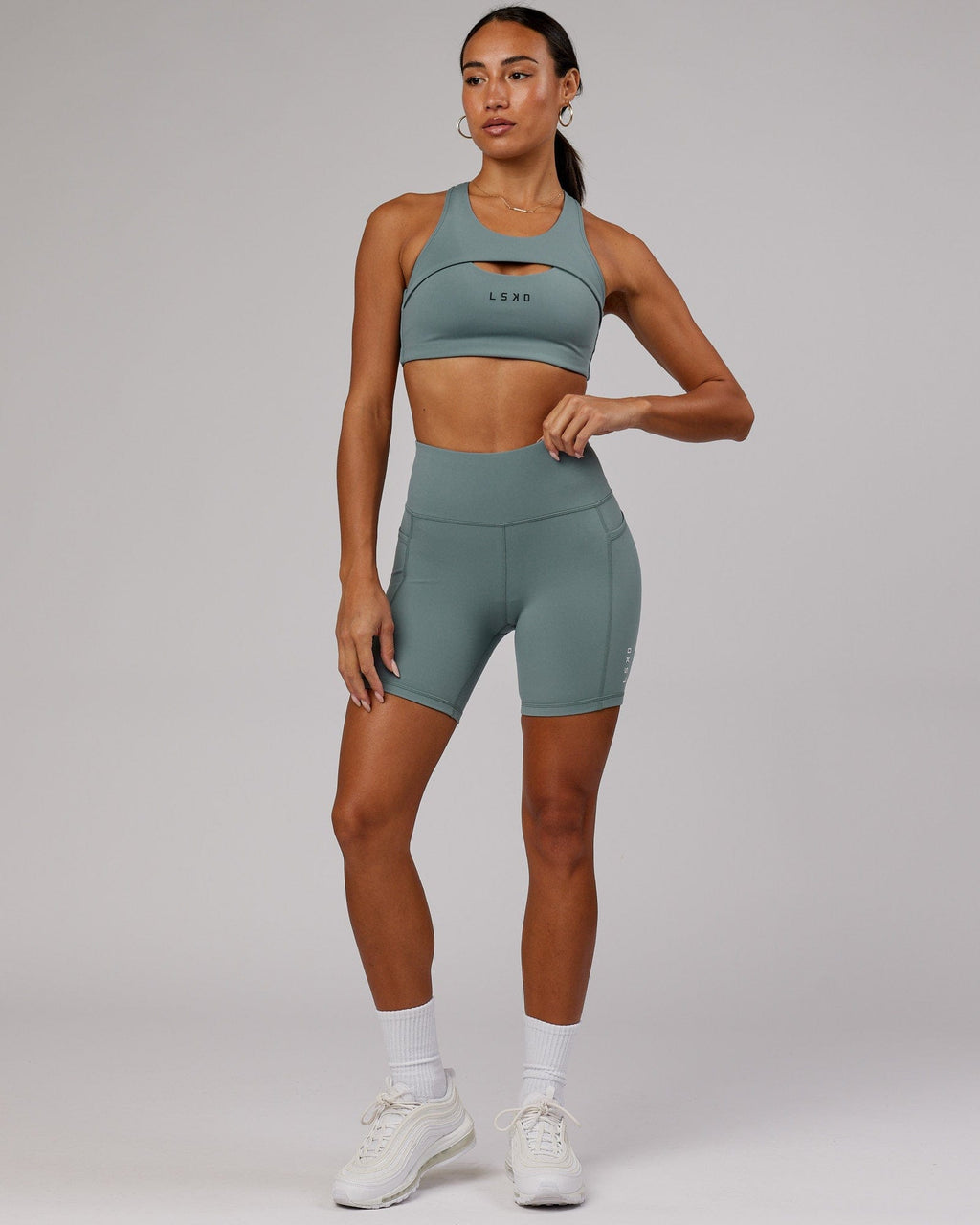 Model wearing Rep Mid Short Tight Small Logo - Eclipse