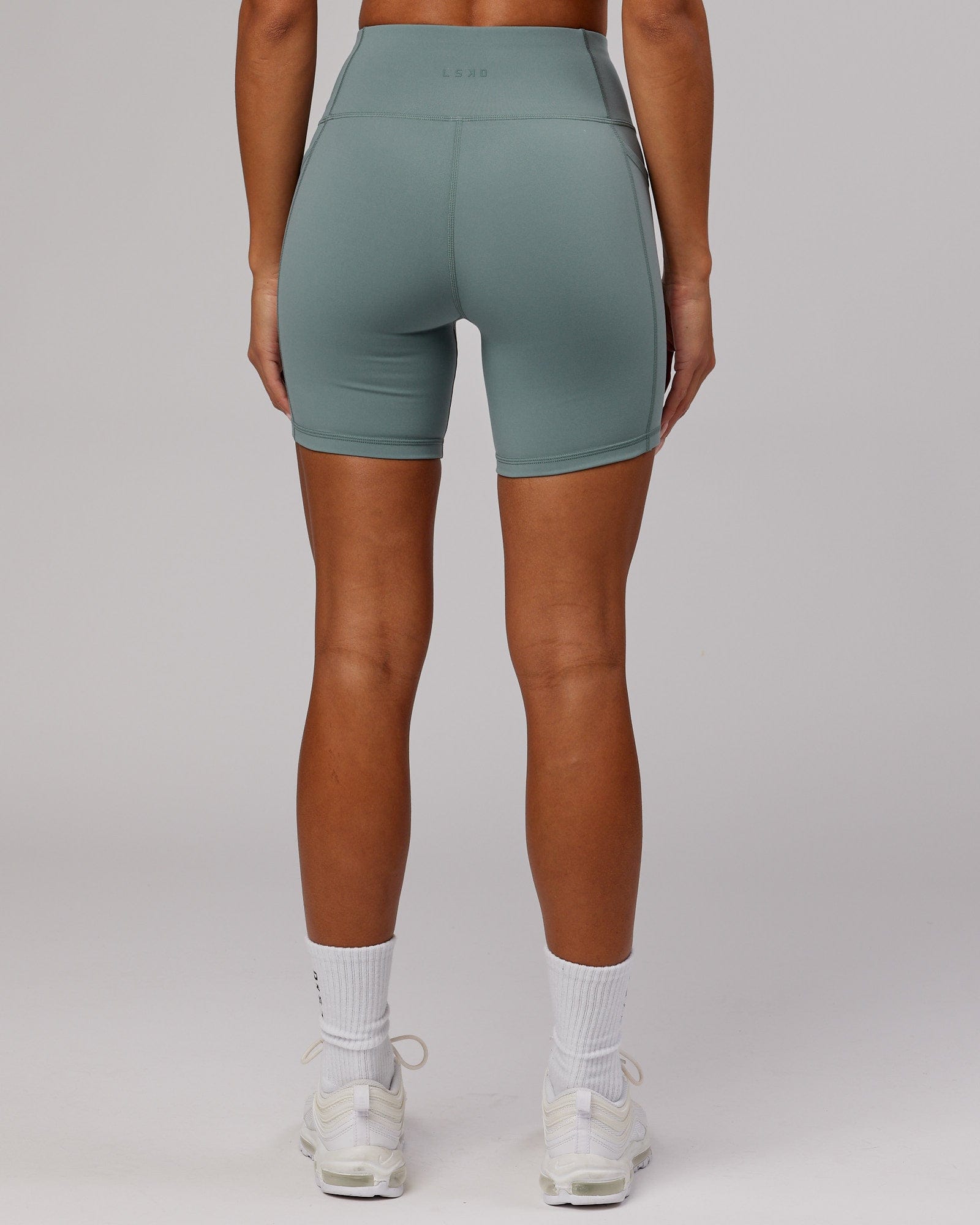 Model wearing Rep Mid Short Tight Small Logo - Eclipse