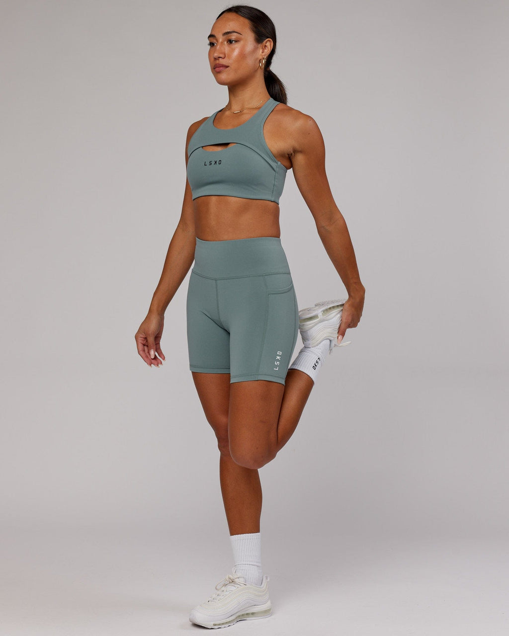 Model wearing Rep Mid Short Tight Small Logo - Eclipse