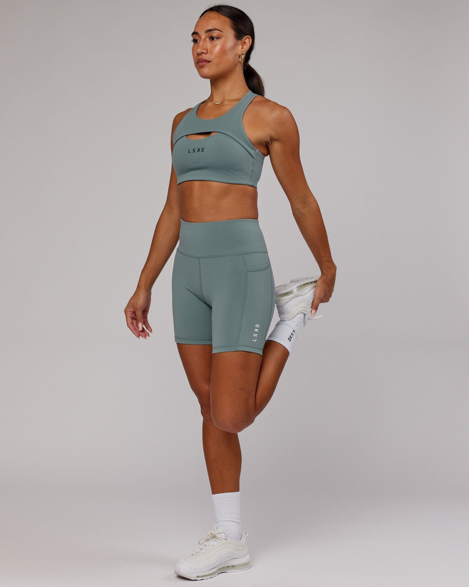 Model wearing Rep Mid Short Tight Small Logo - Eclipse