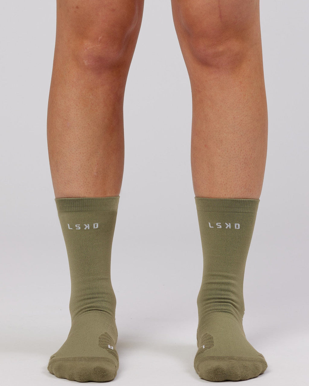 Model wearing Rep Performance Crew Sock - Olive Fade