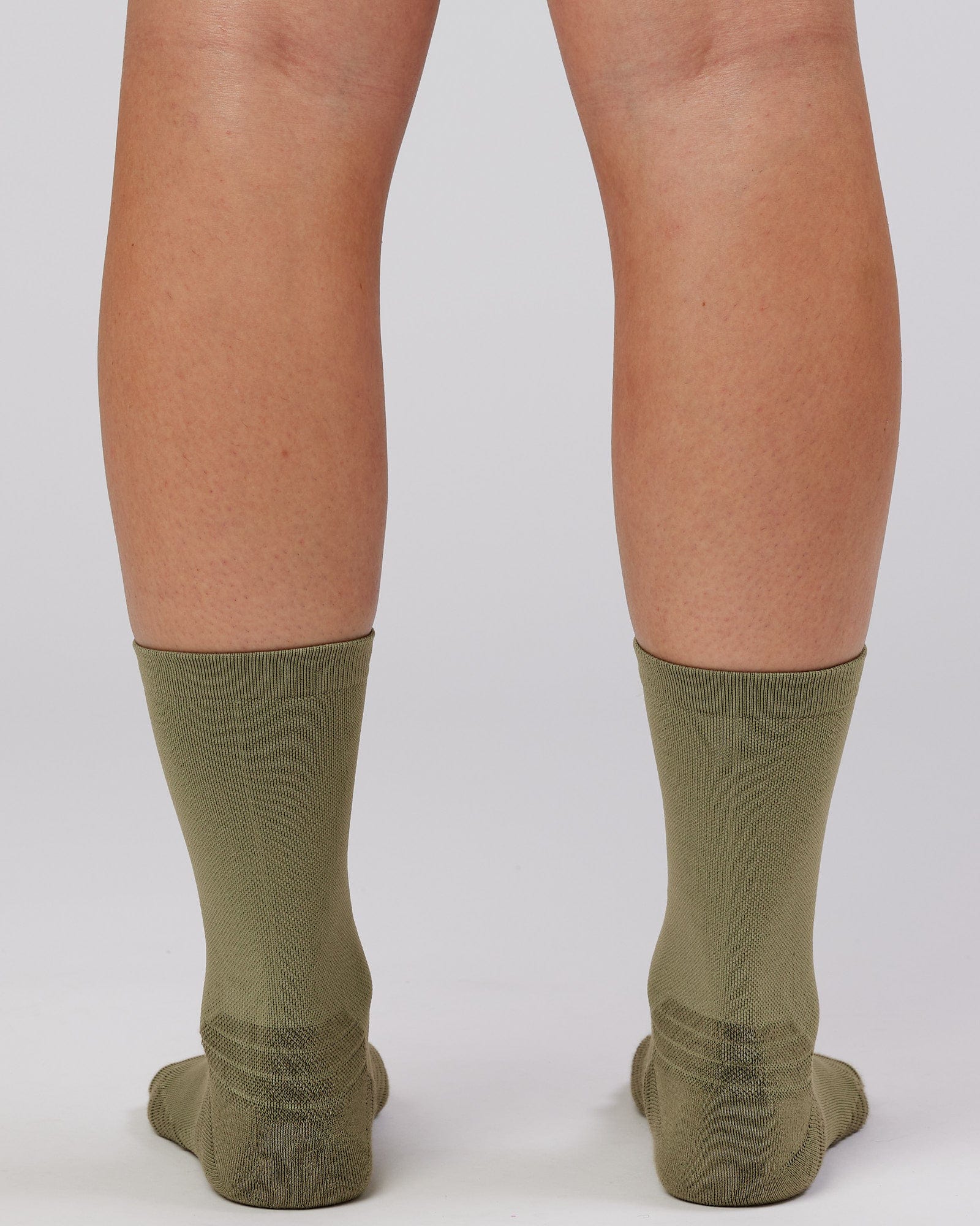 Model wearing Rep Performance Crew Sock - Olive Fade