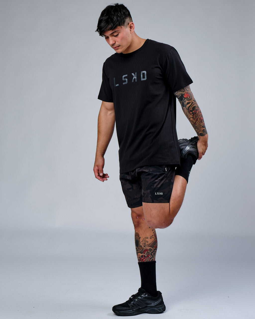 Model wearing Rep 7" Performance Short - Black Camo