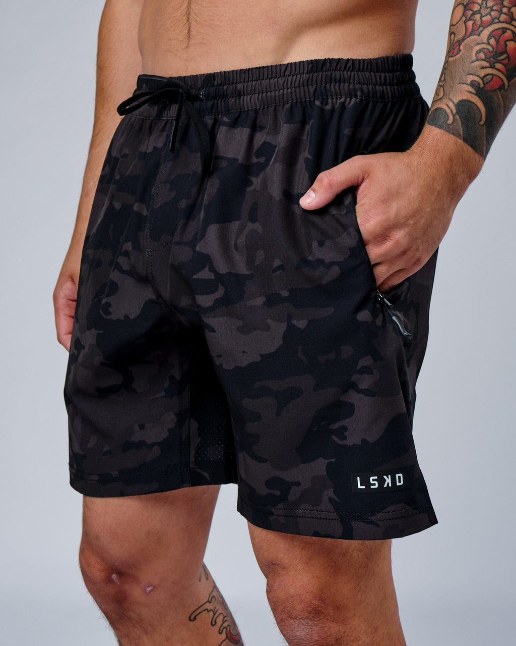 Model wearing Rep 7" Performance Short - Black Camo