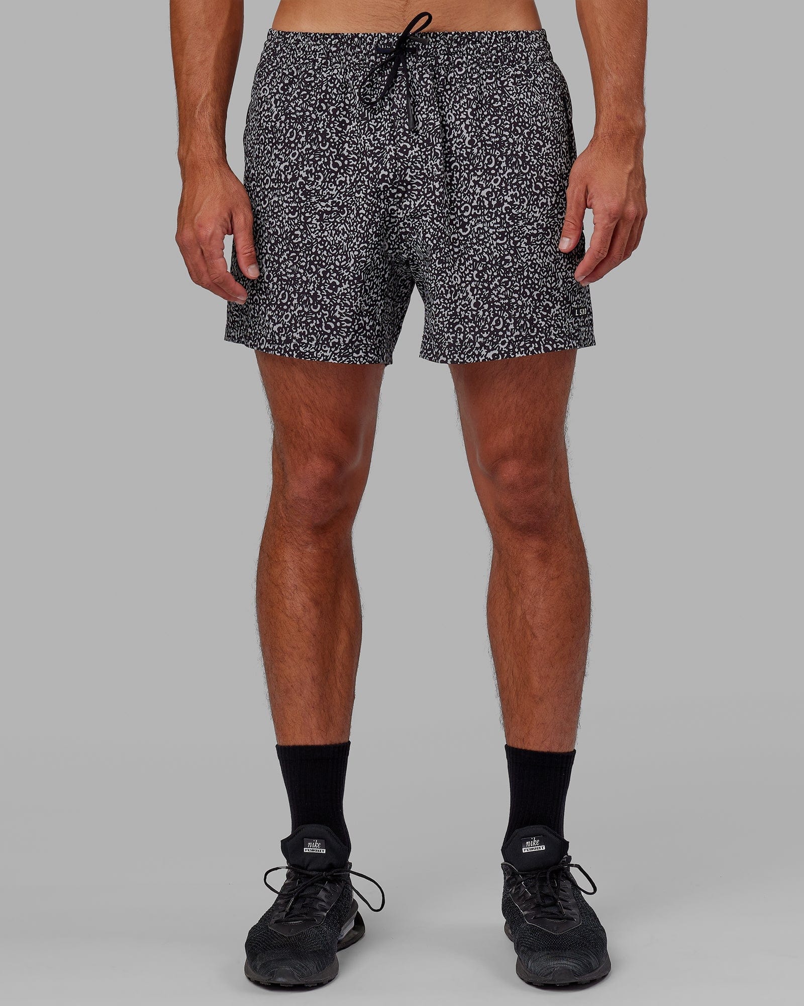Model wearing Rep 5" Performance Short - Spotty Black-Alloy