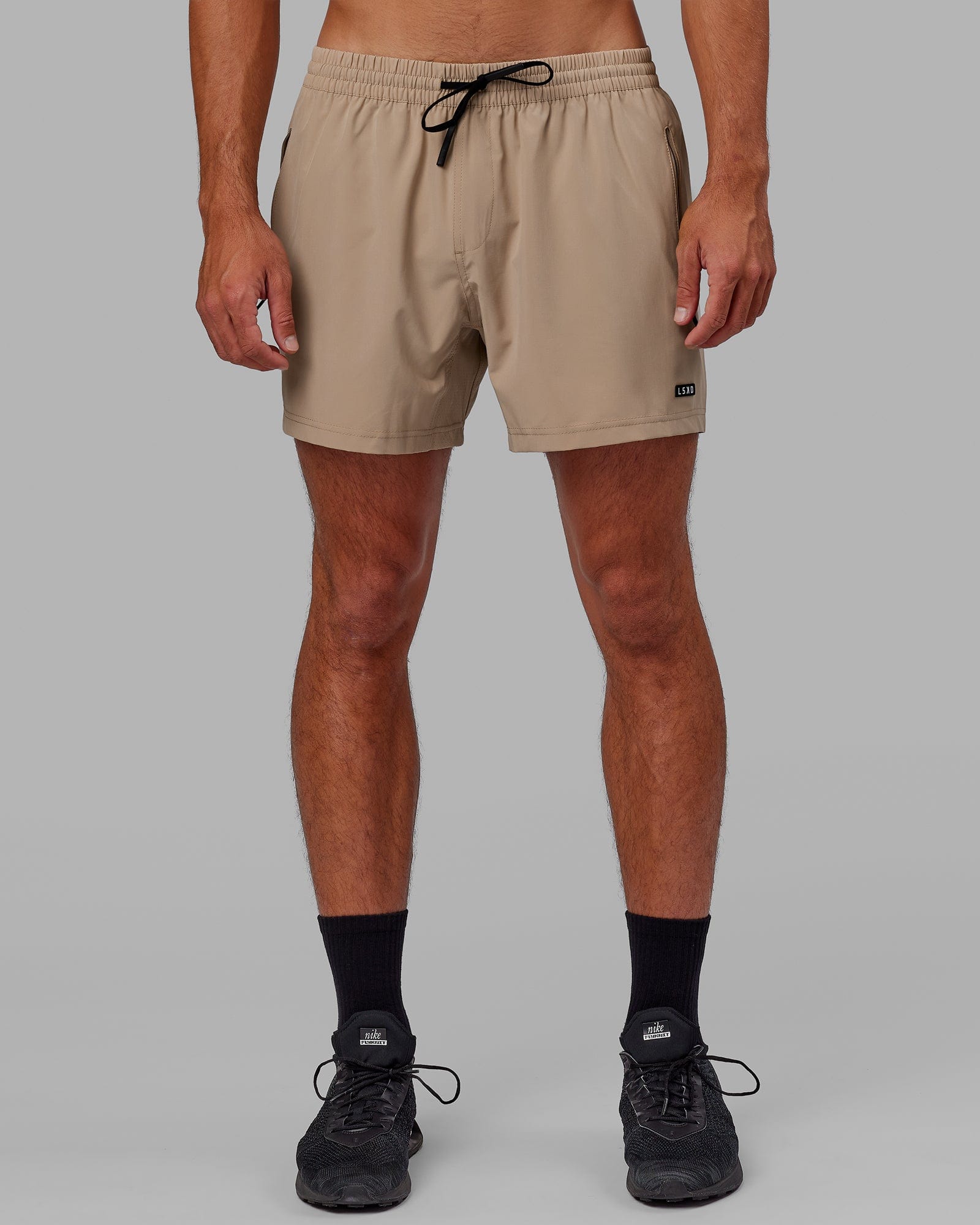 Model wearing Rep 5" Performance Short - Taupe