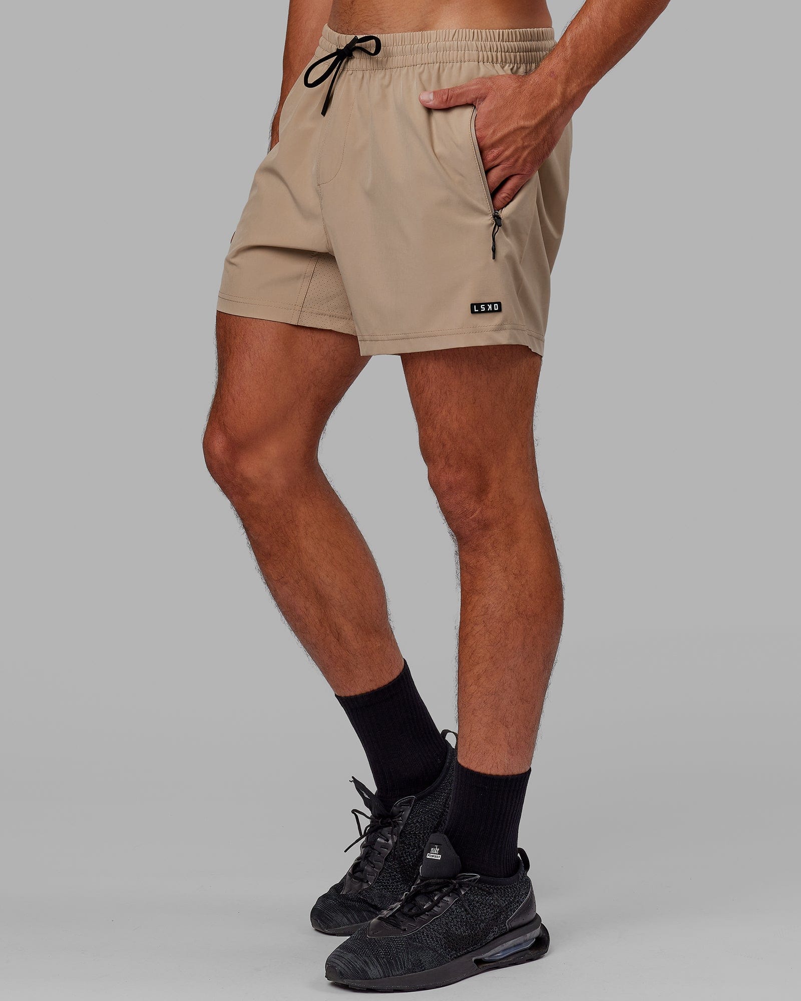 Model wearing Rep 5" Performance Short - Taupe