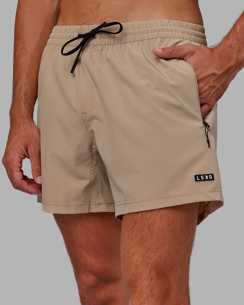 Model wearing Rep 5" Performance Short - Taupe