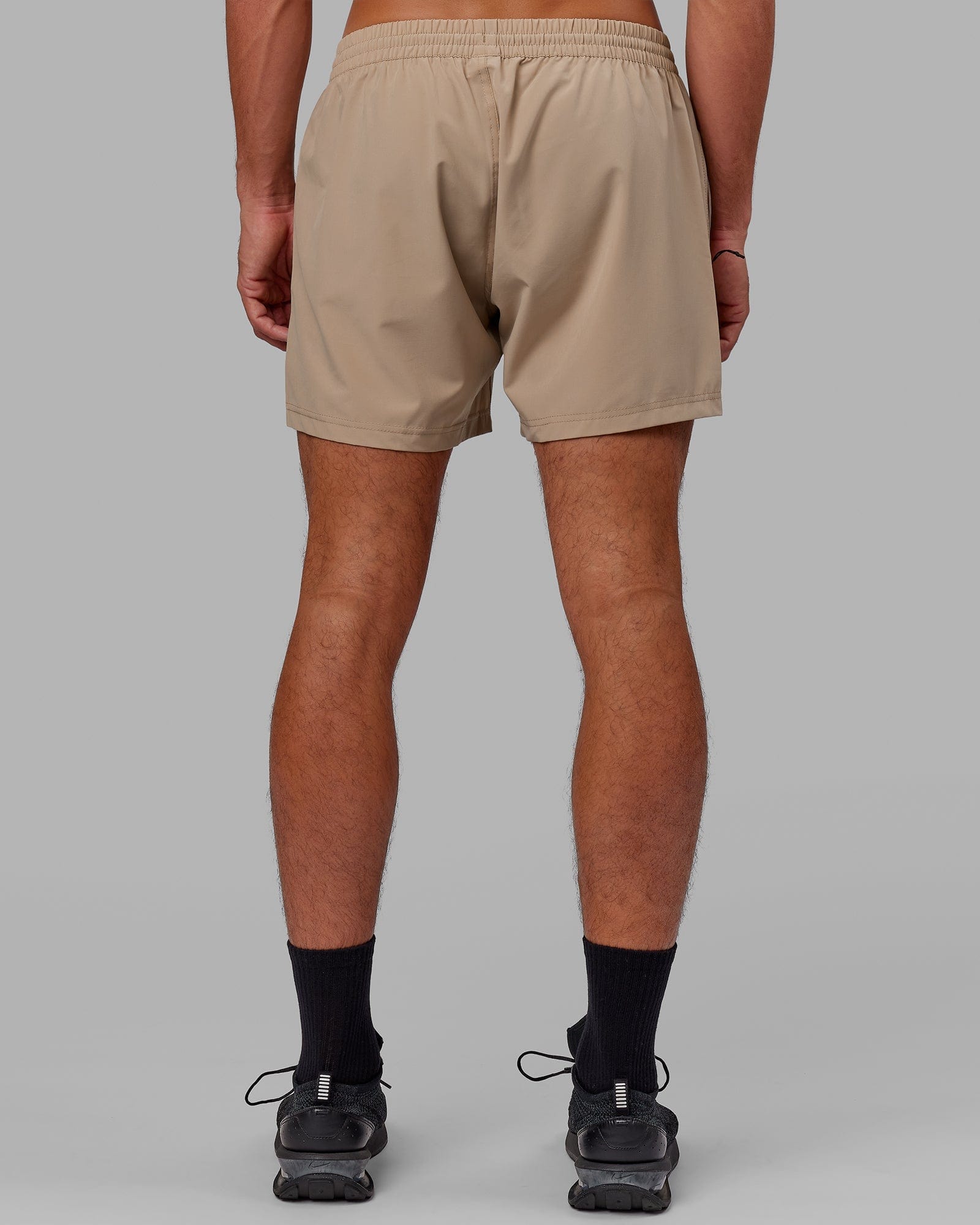 Model wearing Rep 5" Performance Short - Taupe