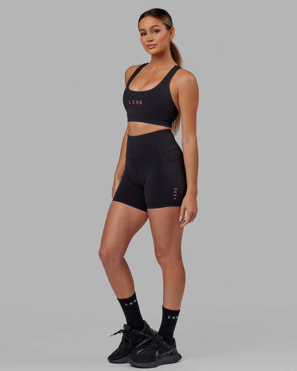 Model wearing Rep Sports Bra Small Logo - Black-Boysenberry