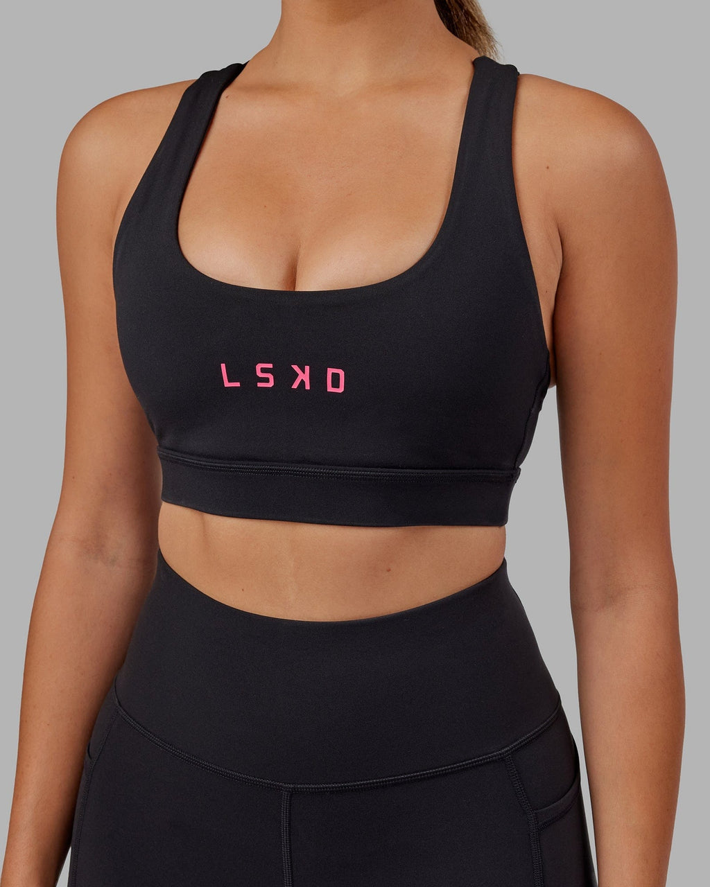 Model wearing Rep Sports Bra Small Logo - Black-Boysenberry