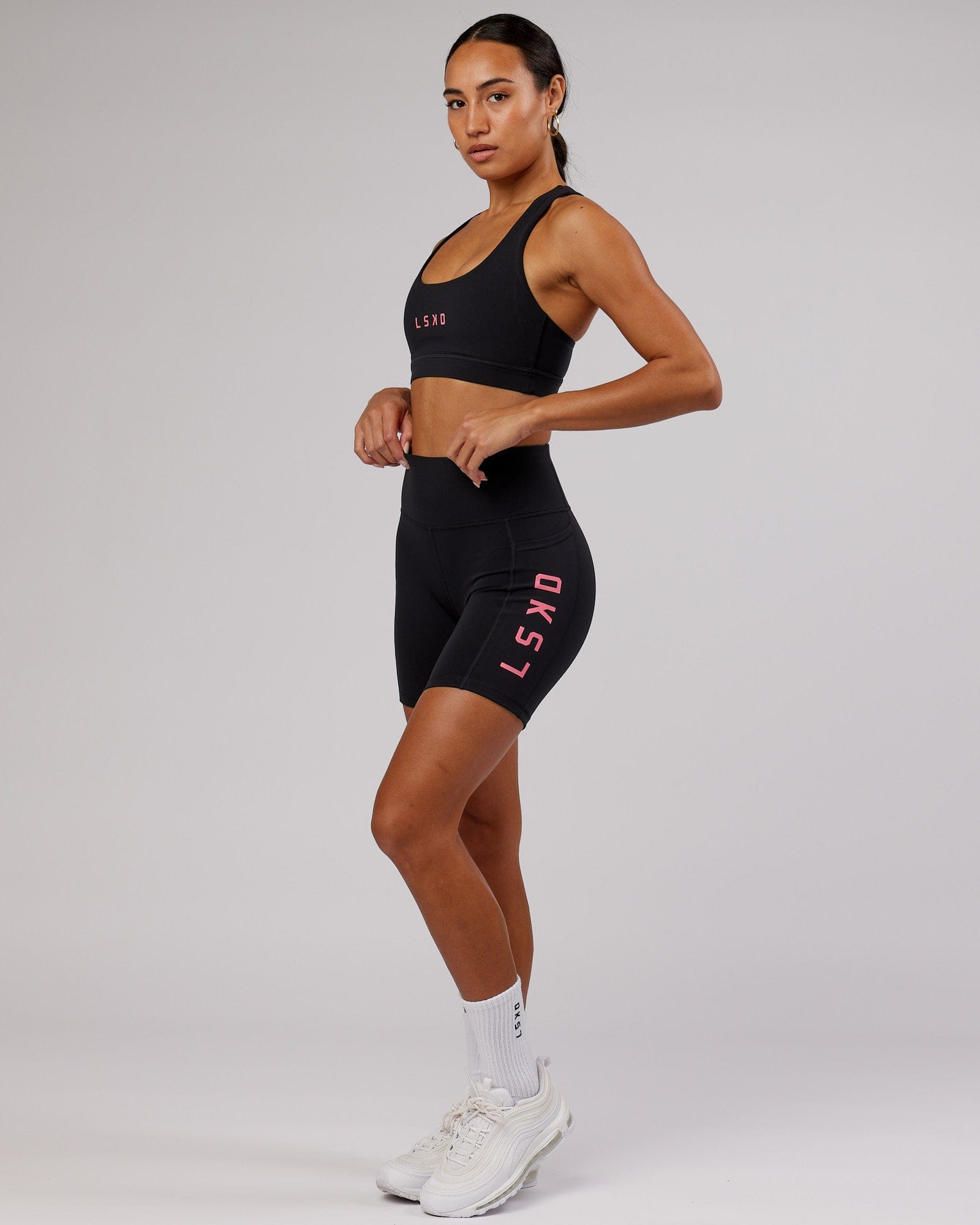 Model wearing Rep Sports Bra Small Logo - Black-Flamingo
