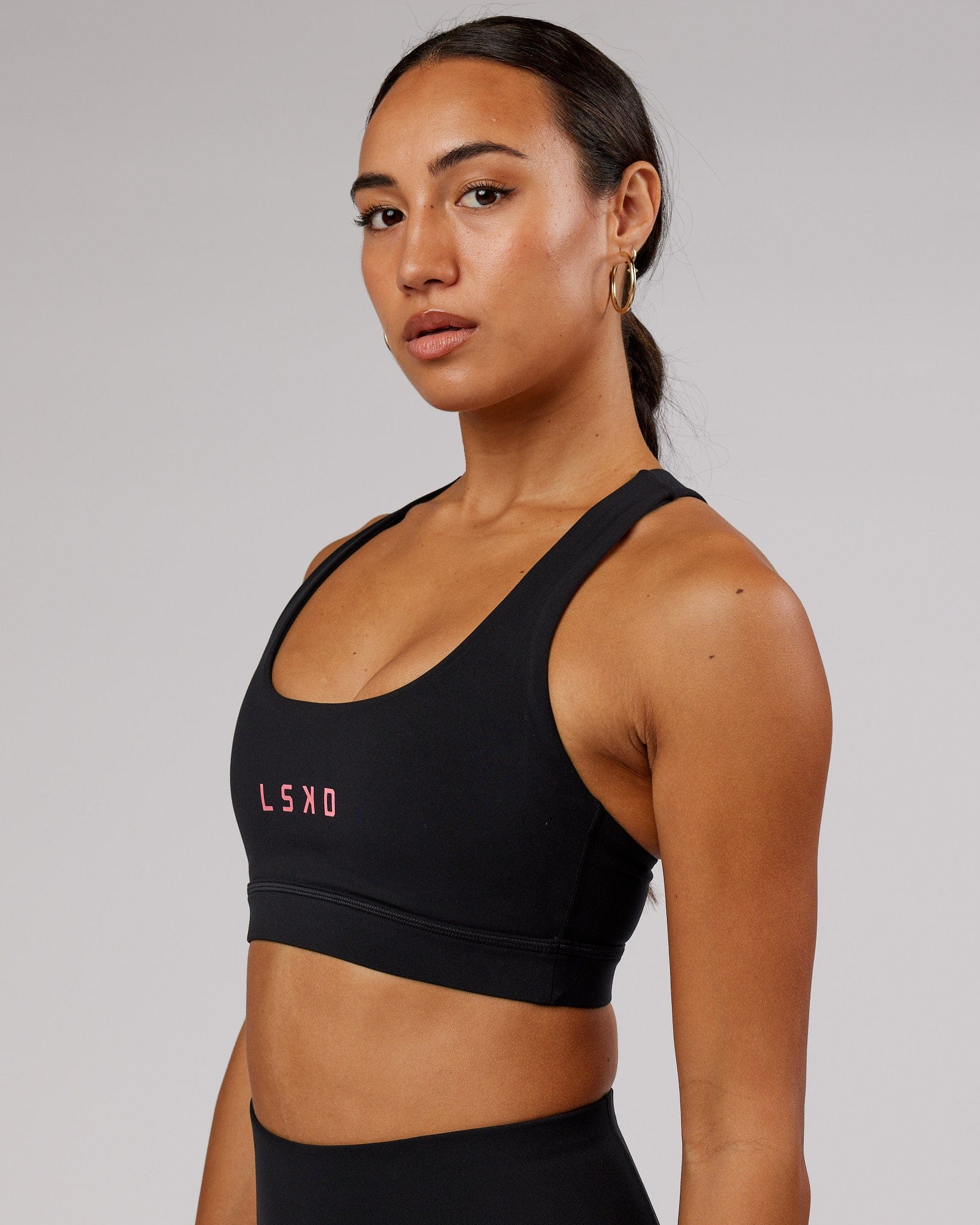 Model wearing Rep Sports Bra Small Logo - Black-Flamingo