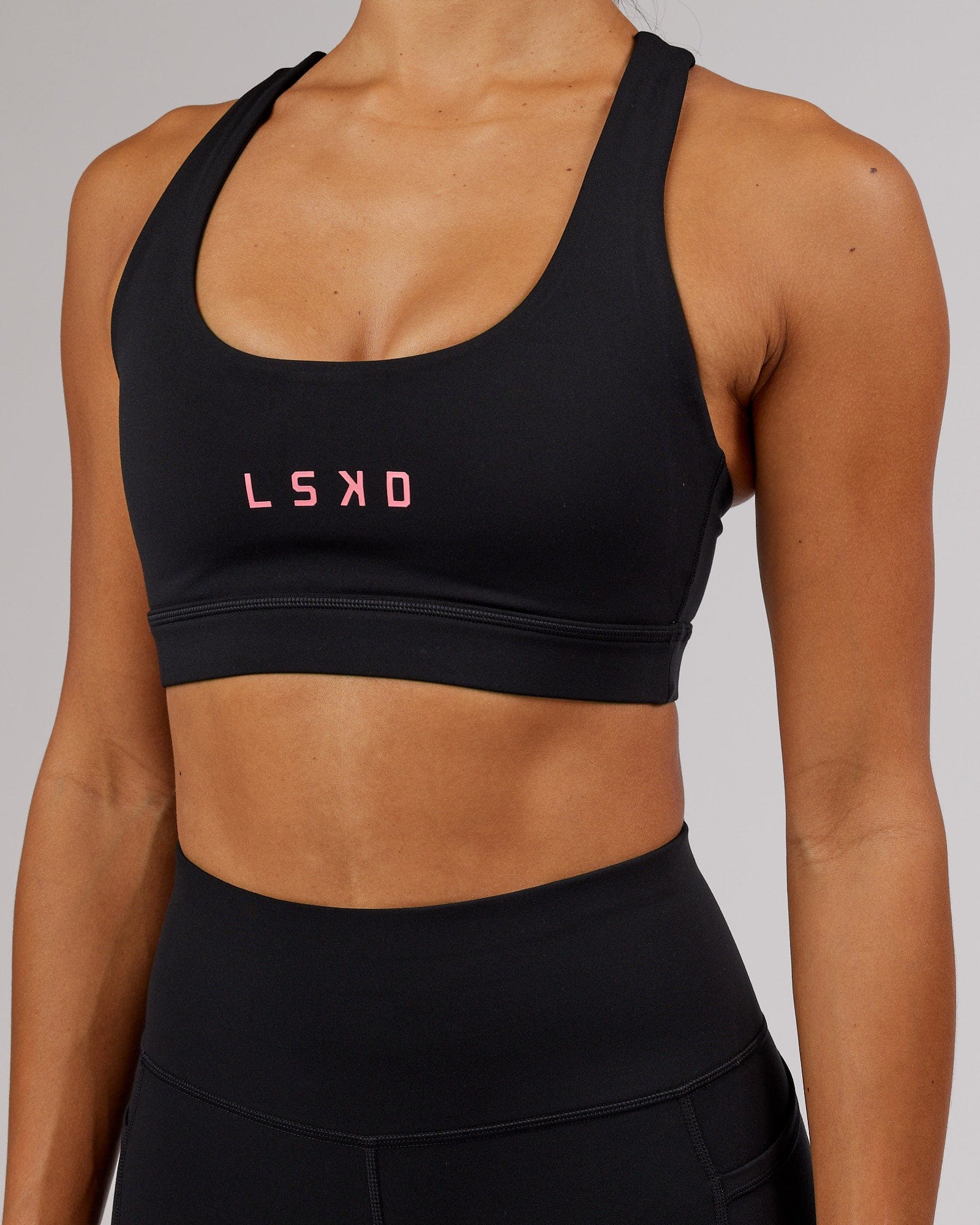 Model wearing Rep Sports Bra Small Logo - Black-Flamingo