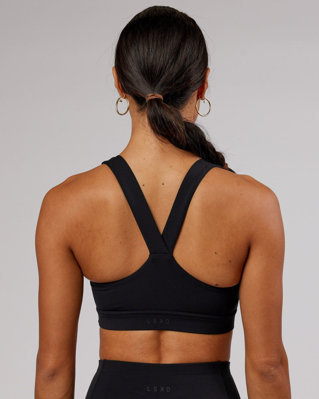 Model wearing Rep Sports Bra Small Logo - Black-Flamingo