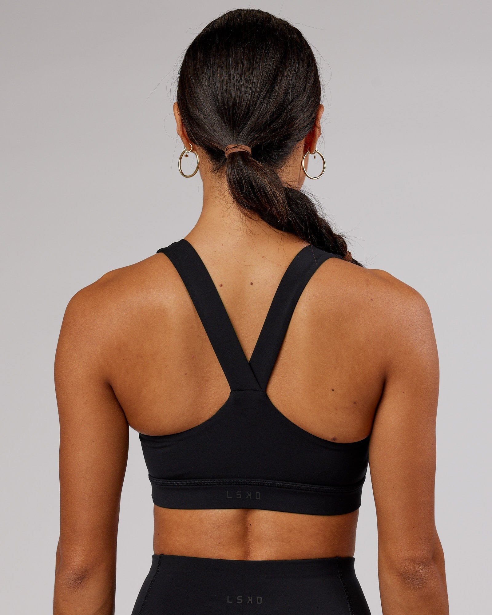 Model wearing Rep Sports Bra Small Logo - Black-Flamingo