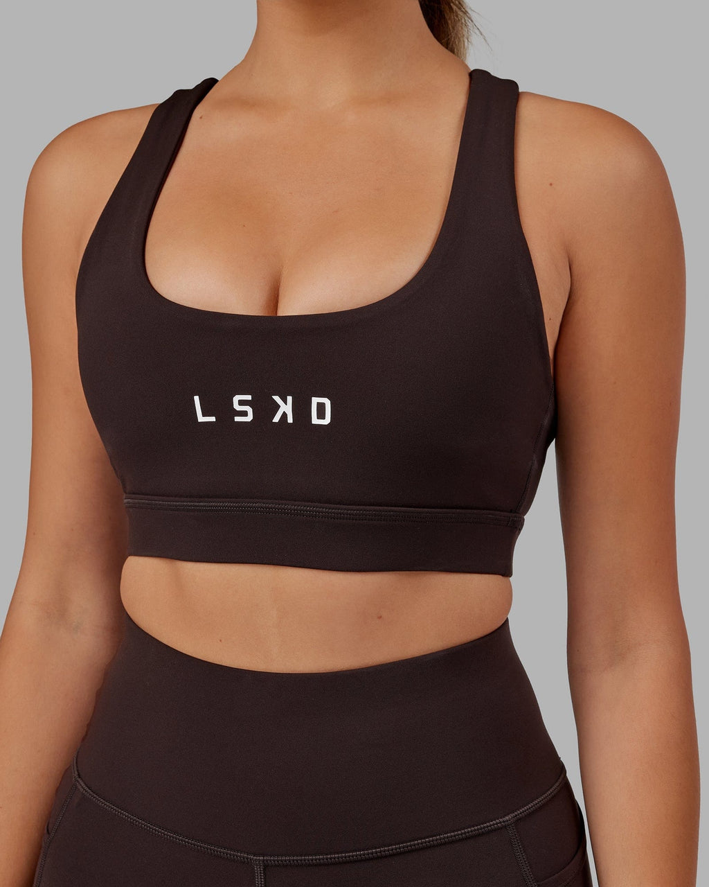 Model wearing Rep Sports Bra Small Logo - Dark Walnut