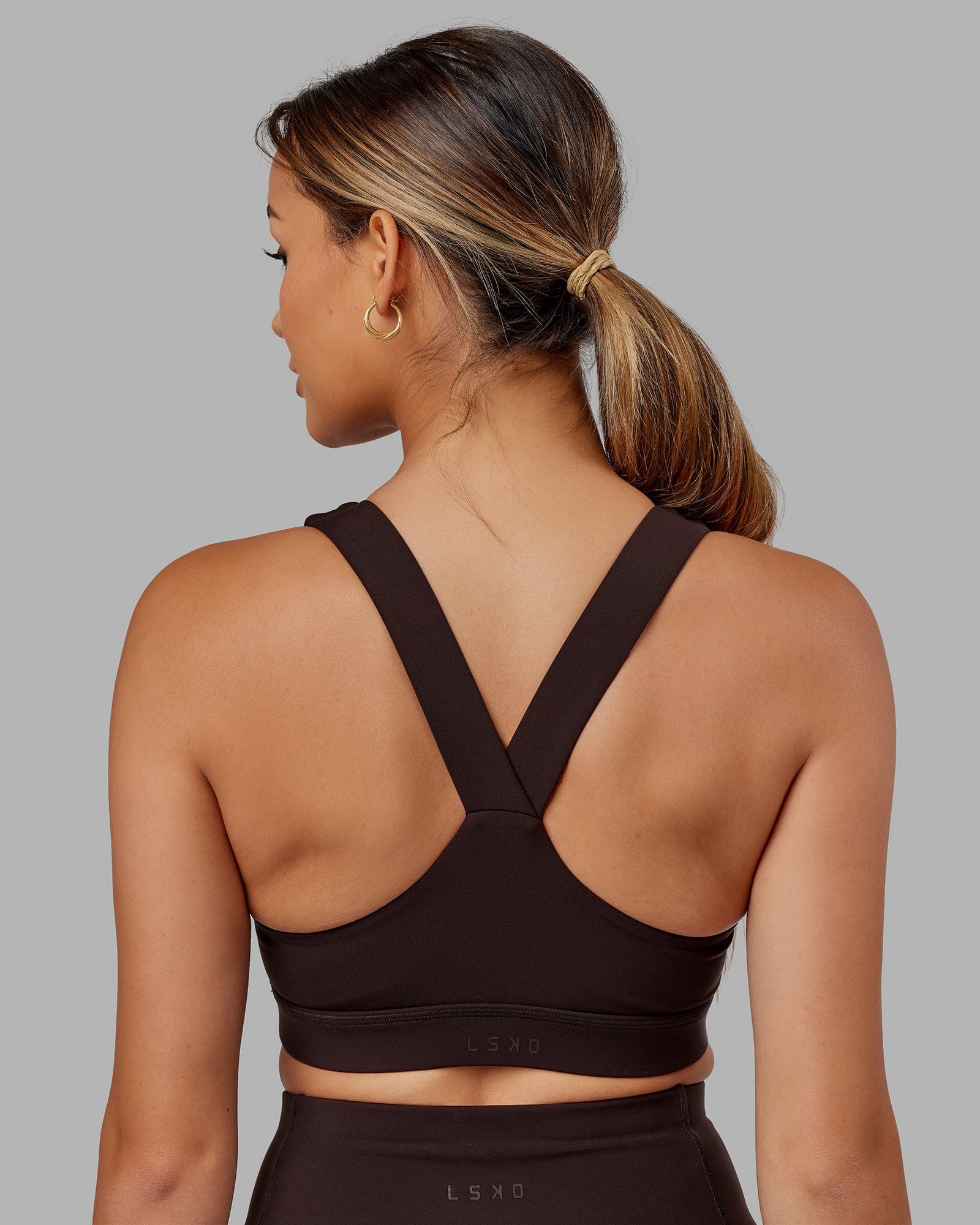Model wearing Rep Sports Bra Small Logo - Dark Walnut