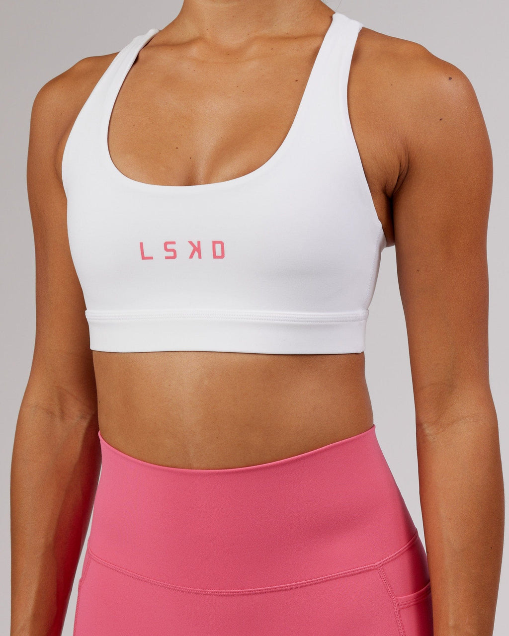 Model wearing Rep Sports Bra Small Logo - White-Flamingo