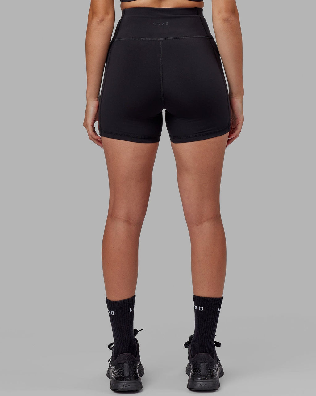 Model wearing Rep X-Short Tight - Black-Boysenberry