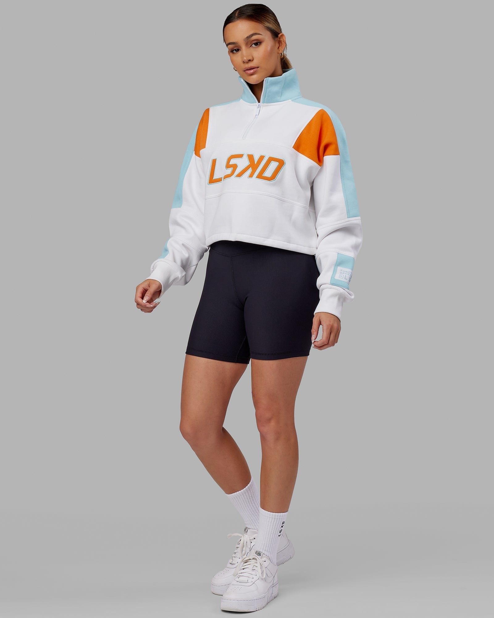 Model wearing Slam 1/4 Zip Sweater - Crystal Blue-Orange