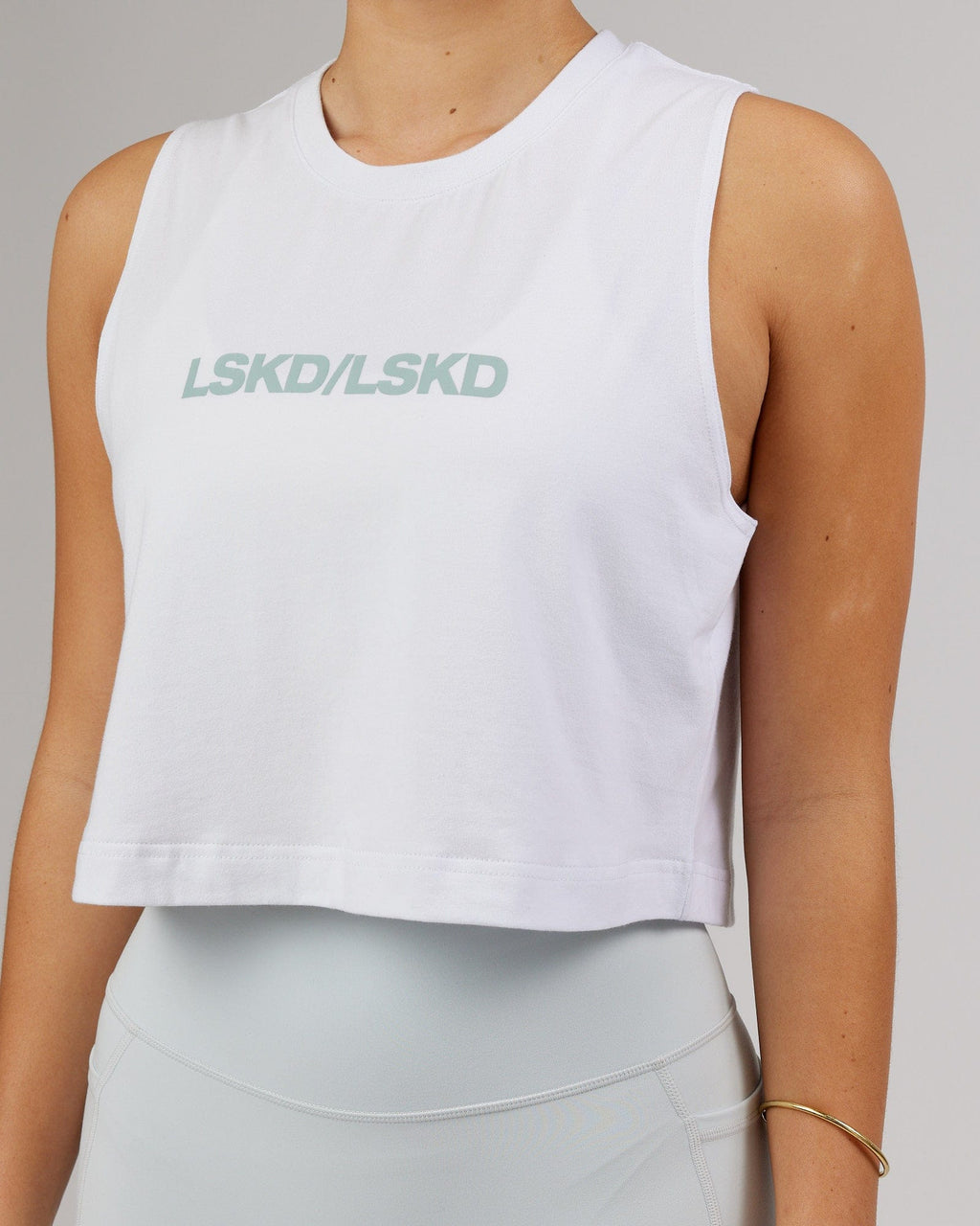 Model wearing Speedway FLXCotton Cropped Tank - White