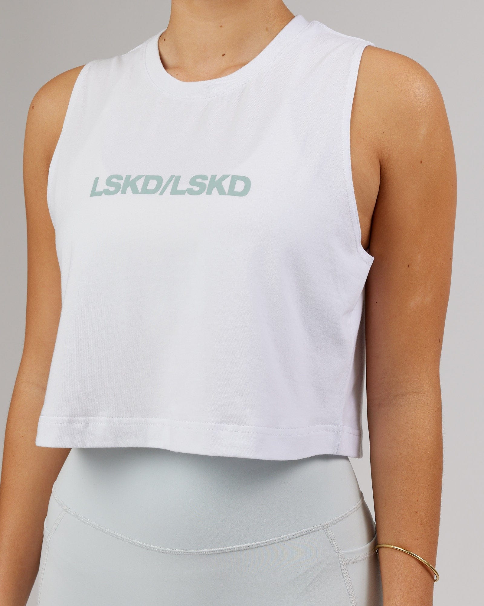 Model wearing Speedway FLXCotton Cropped Tank - White