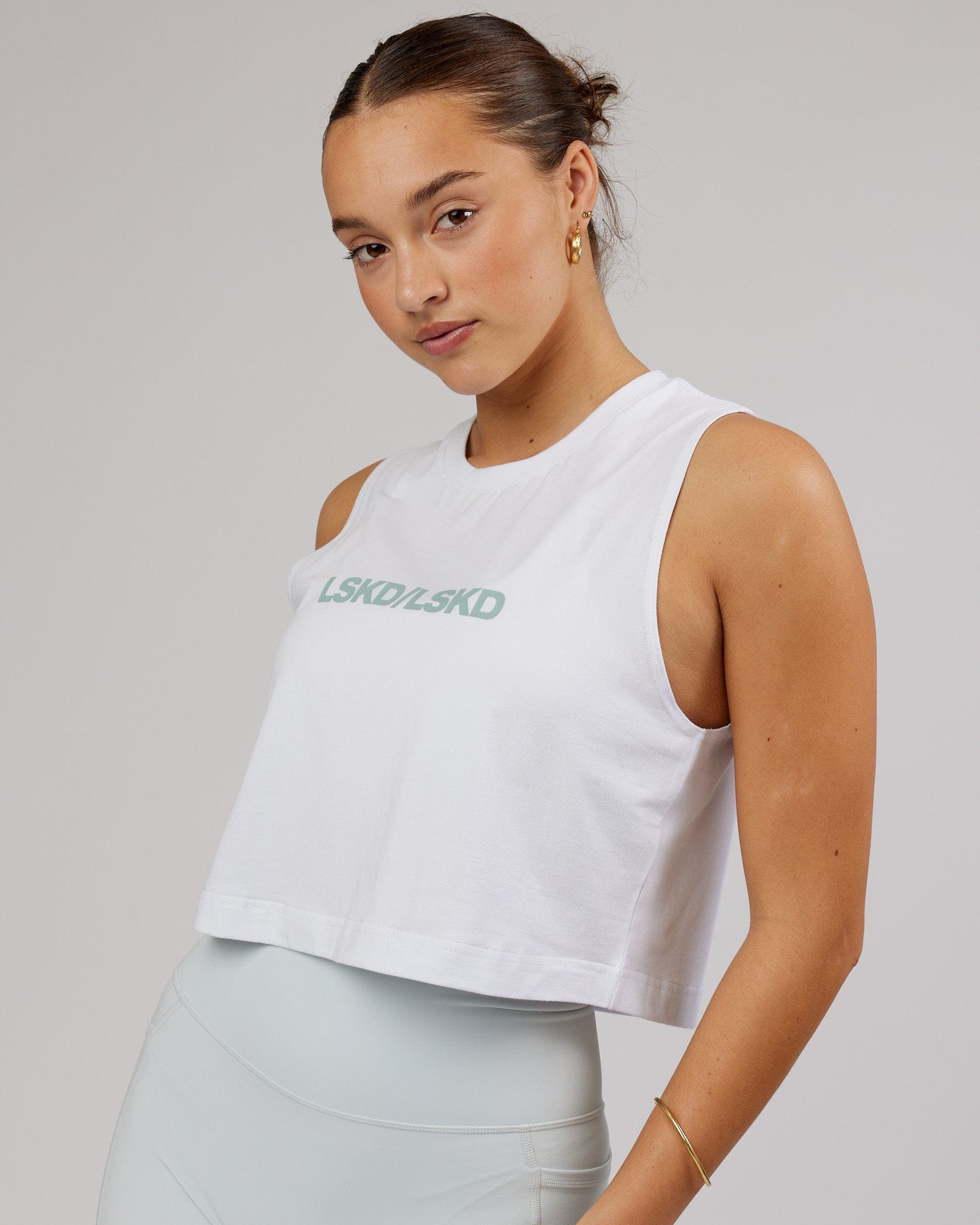 Model wearing Speedway FLXCotton Cropped Tank - White