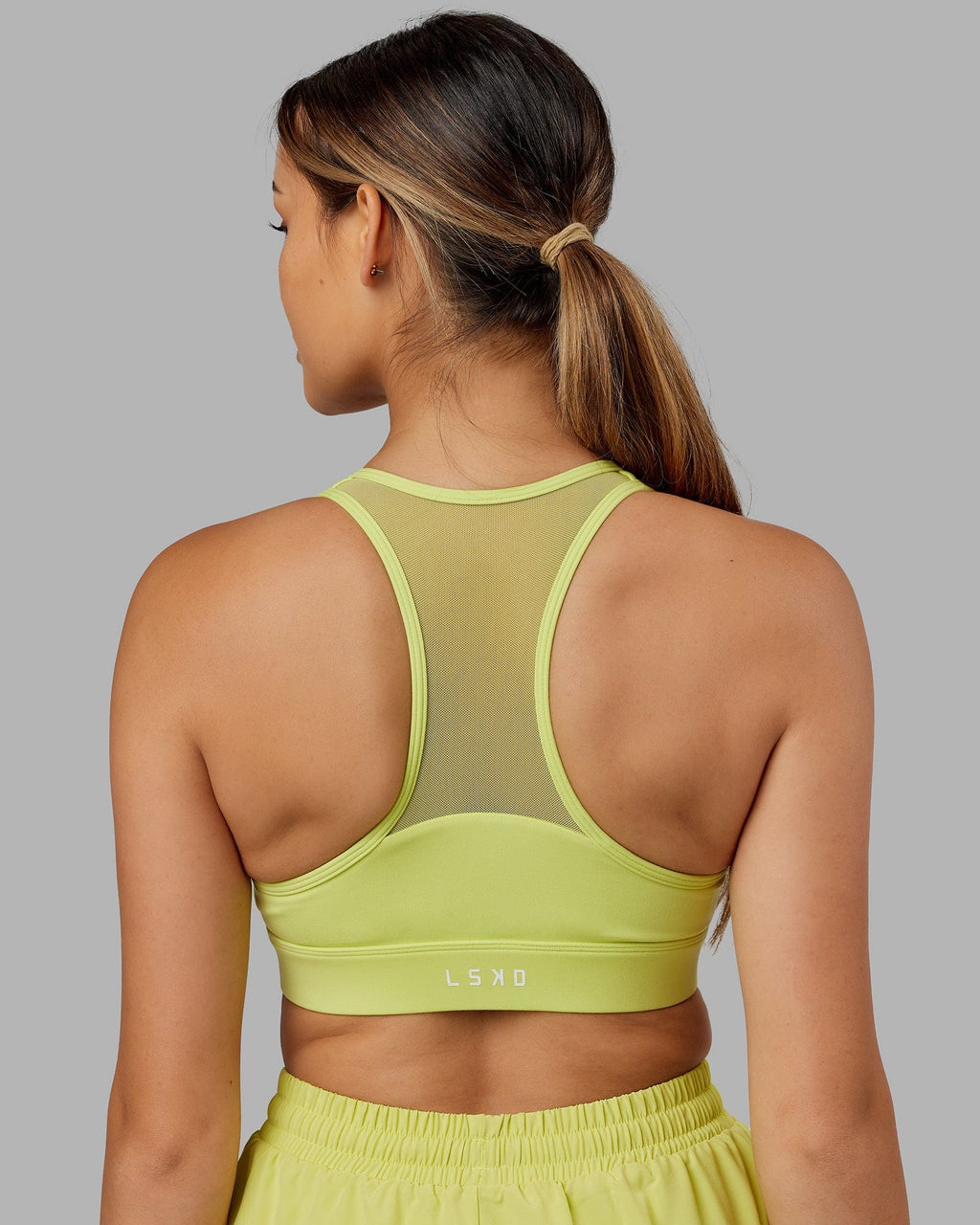 Model wearing Sprint Sports Bra - Citrus Green