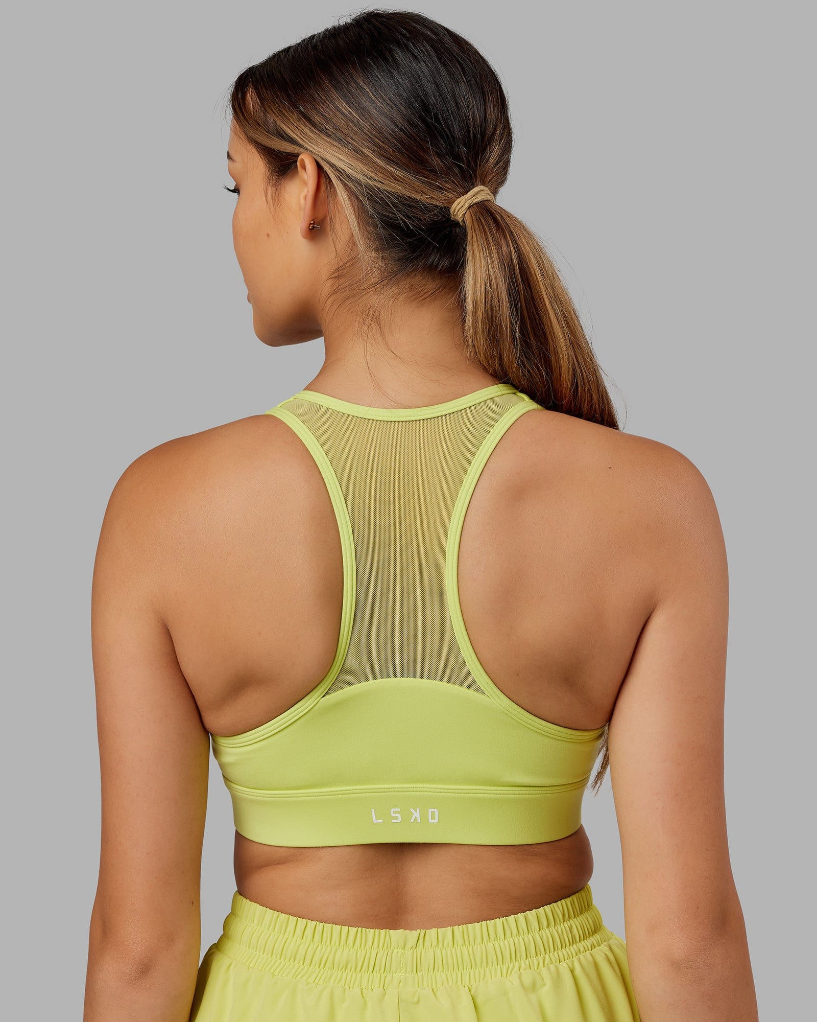 Model wearing Sprint Sports Bra - Citrus Green