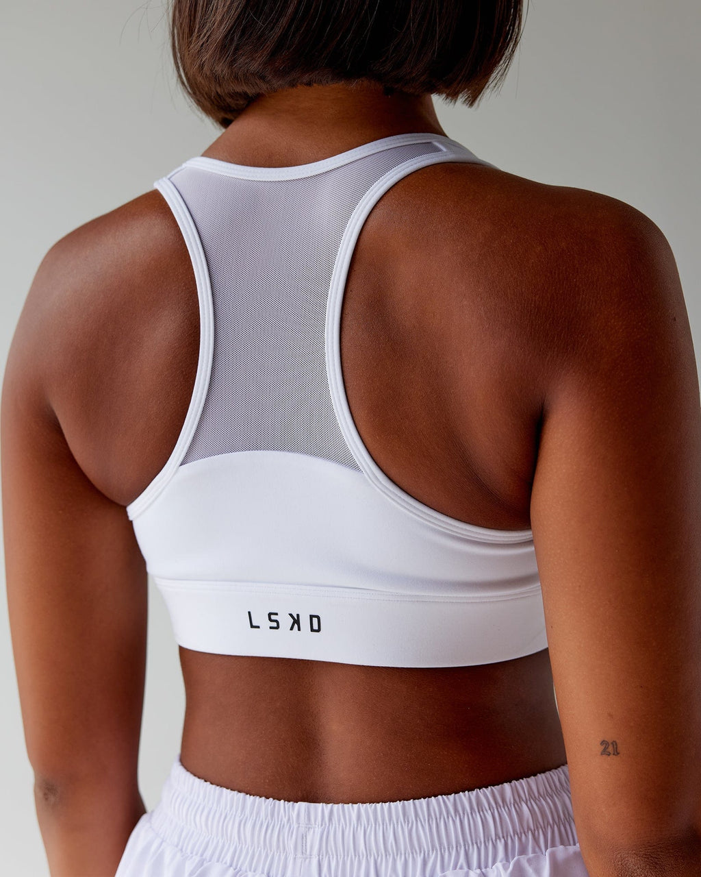 Model wearing Sprint Sports Bra - White