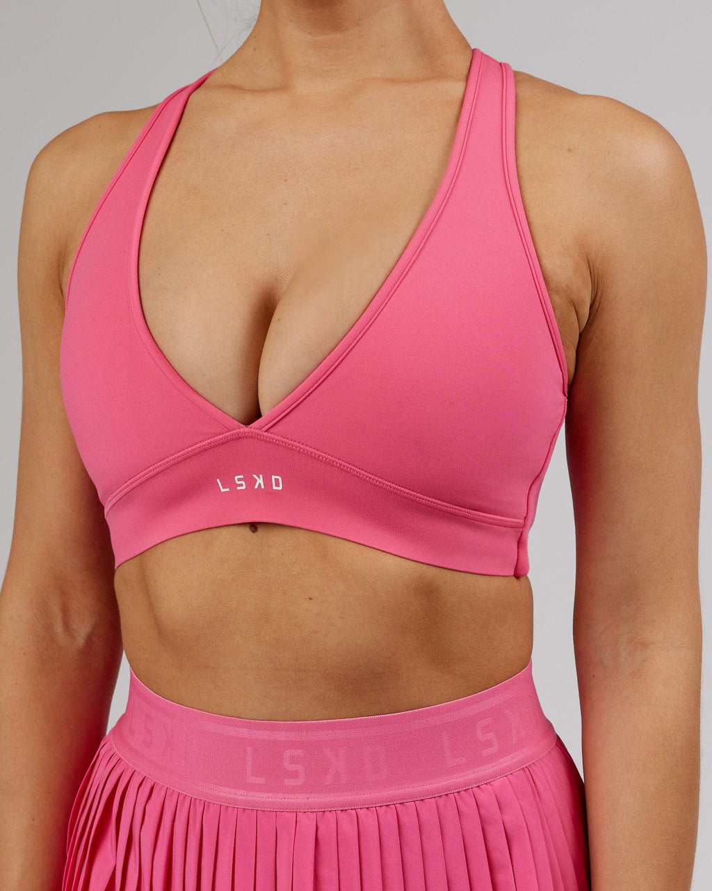 Model wearing Stamina Sports Bra - Flamingo