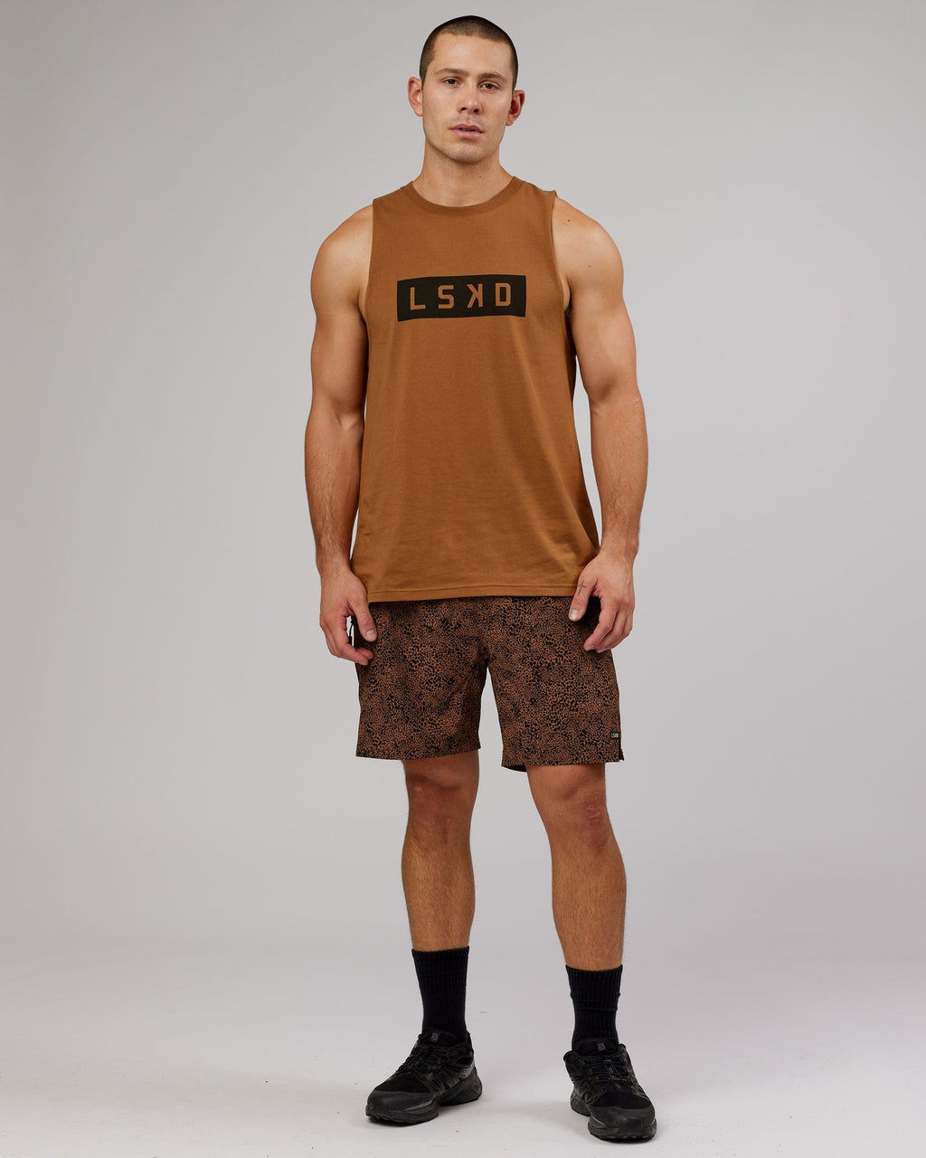 Model wearing Strength FLXDRY Training Fit Performance Tank - Camel