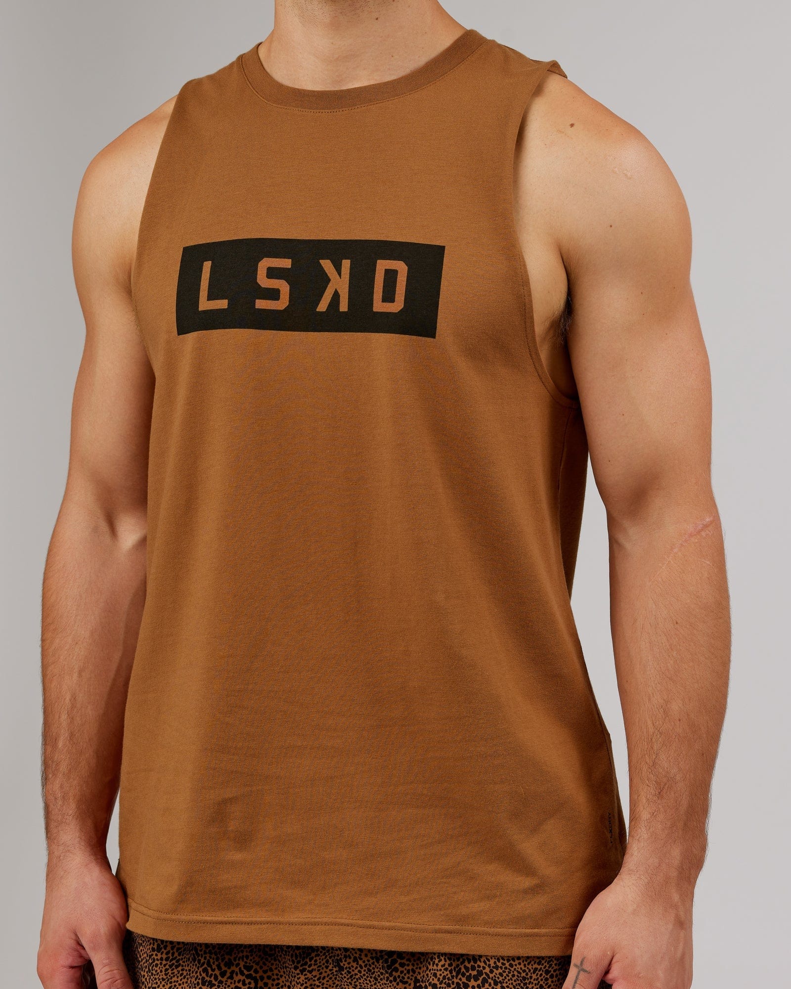 Model wearing Strength FLXDRY Training Fit Performance Tank - Camel